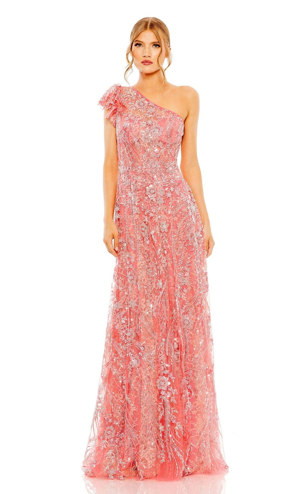 A woman in the Mac Duggal Long Formal Dress 68512, a coral pink one-shoulder gown with floral embroidery and bead detailing, poses against a plain white background.
