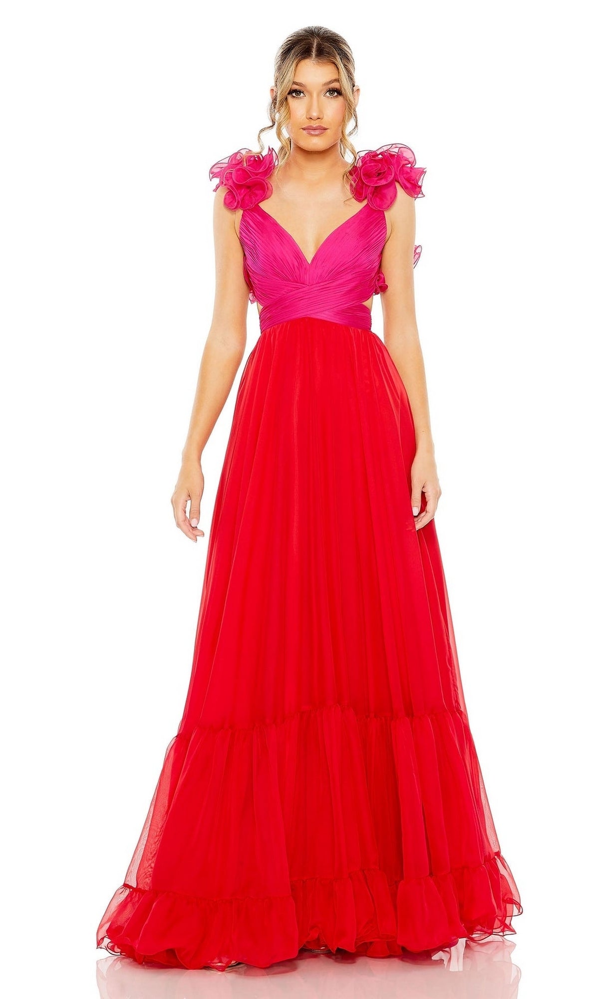 A woman stands facing forward against a white background wearing the Long Formal Dress 68522 by Mac Duggal—a bright pink, v-neck, ruffle tiered dress with a full layered skirt and ruffled shoulder accents.