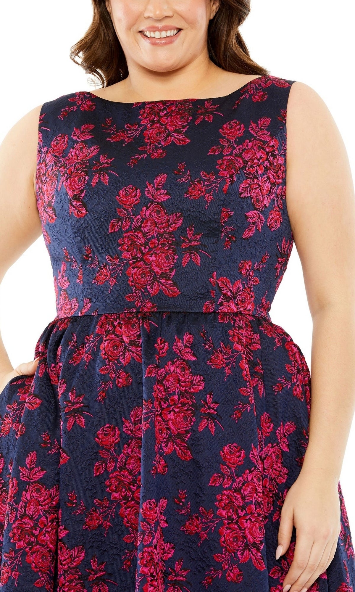 A woman confidently poses with one hand on her hip in the Plus-Size Knee-Length Print Party Dress 68557, featuring a sleeveless design and stylish floral pattern.