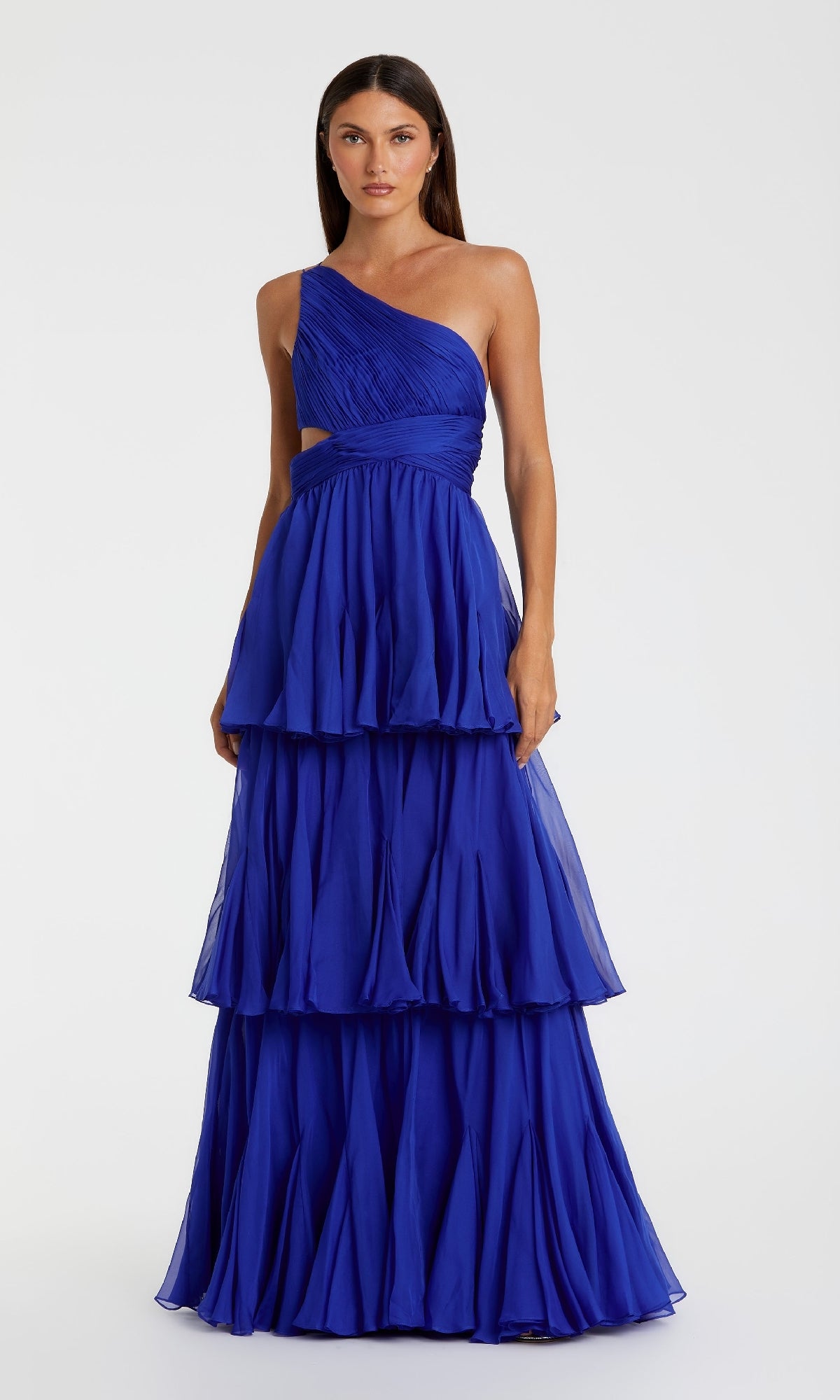 A woman poses against a white backdrop in the One-Shoulder Blue Formal Dress: Mac Duggal 68846, showcasing its elegant tiered layers and modern silhouette for a sophisticated look.