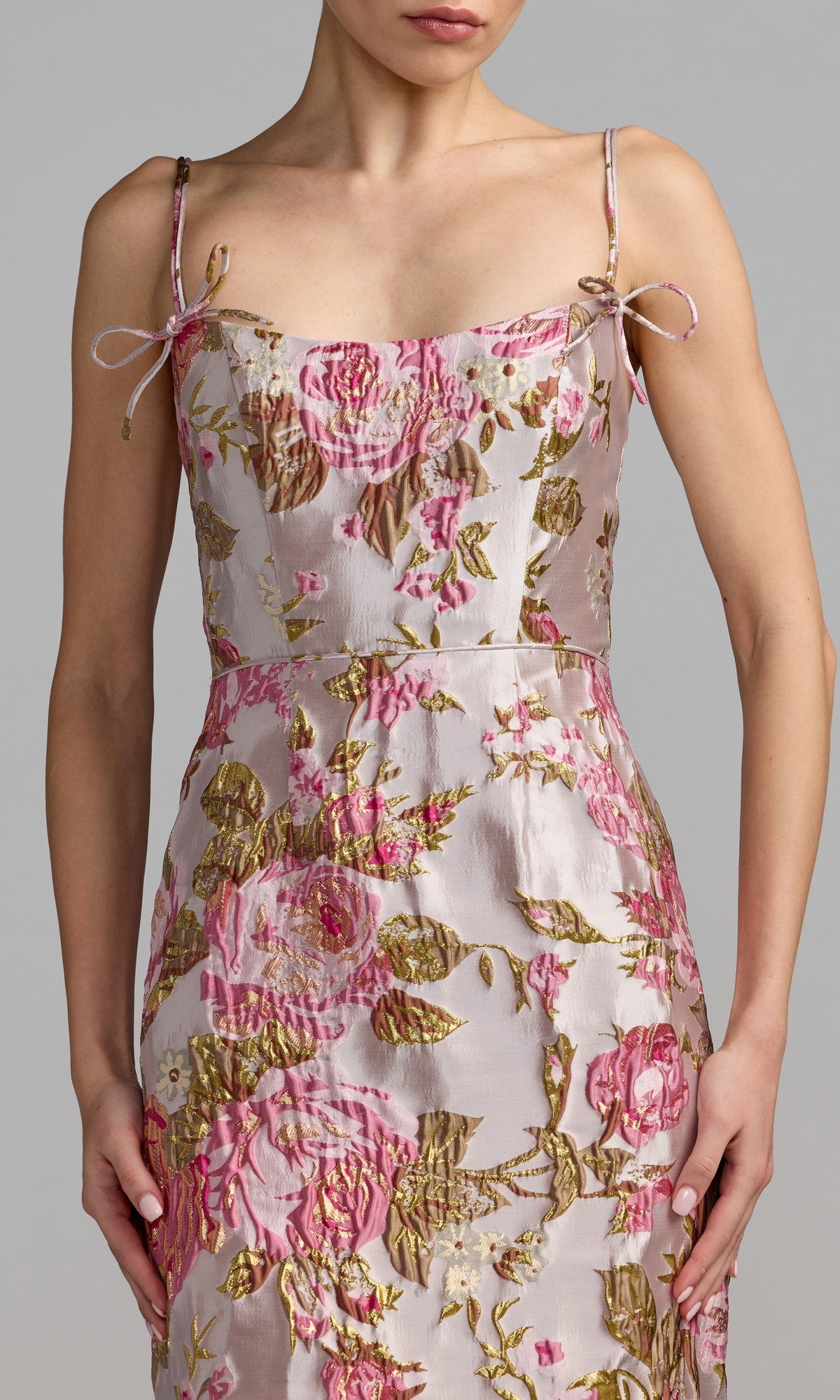 A person wears the Mac Duggal 69153 Midi Party Dress, a sleeveless party dress with thin straps and a pink and gold floral-brocade pattern, shown from shoulders to knees against a neutral background.