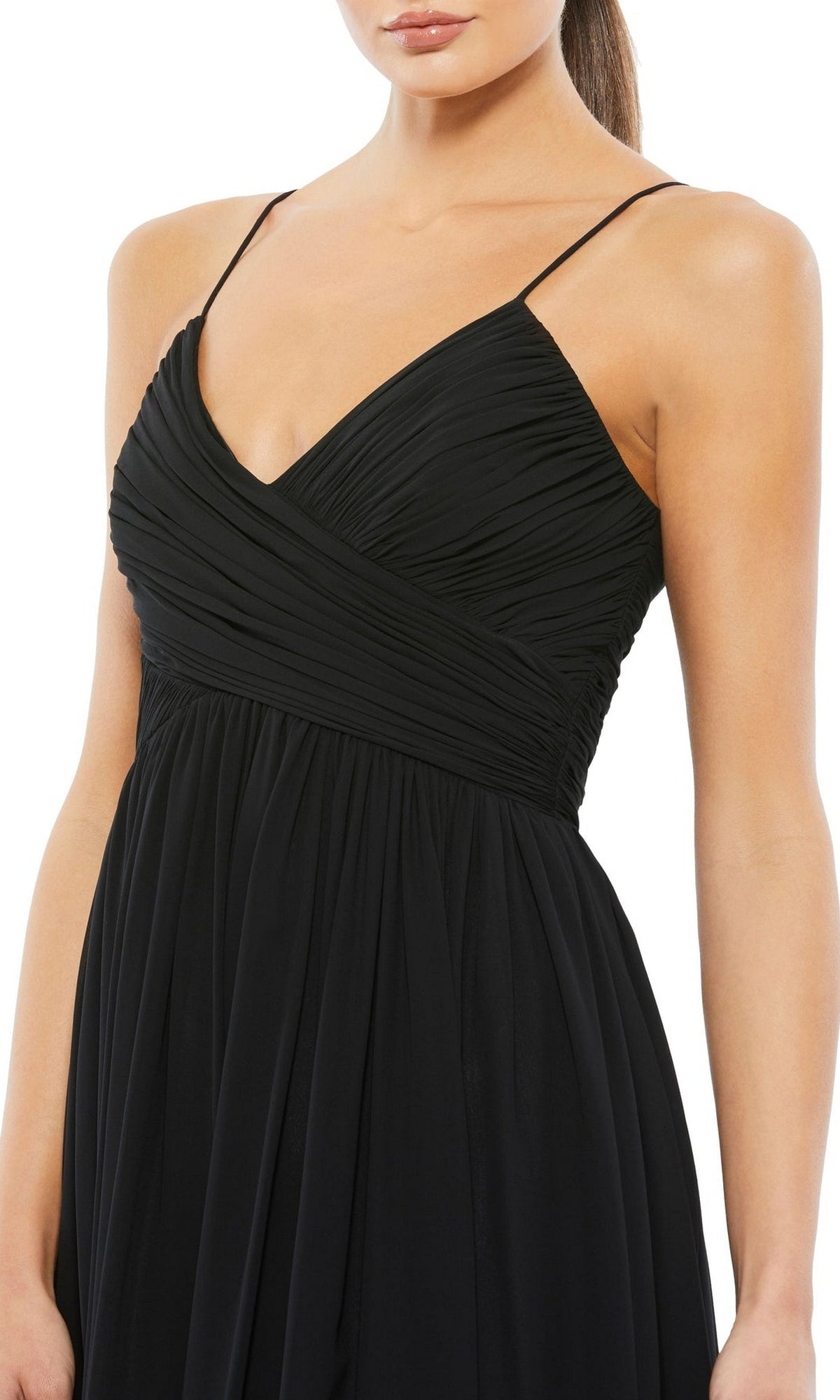 A woman wears the Mac Duggal 70099 A-Line Midi Wedding Guest Dress, featuring a sleeveless black design with thin straps and ruched bodice detail, shown from the shoulders to mid-thigh.