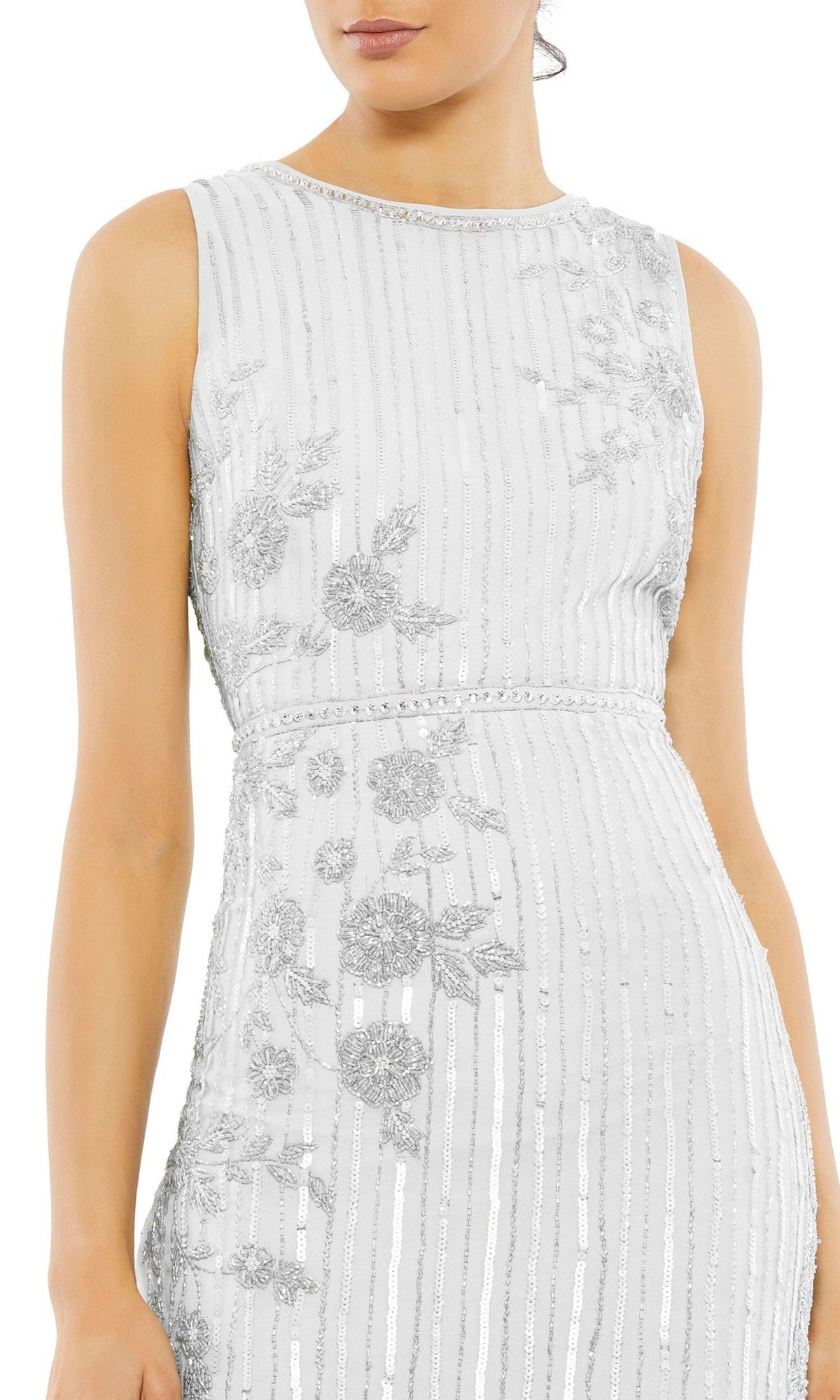 A woman models the Mac Duggal 70260 Beaded Midi Wedding Guest Dress, a sleeveless fitted white dress with silver floral embroidery and vertical beaded stripes, shown from shoulders to mid-thigh to highlight its elegant details.