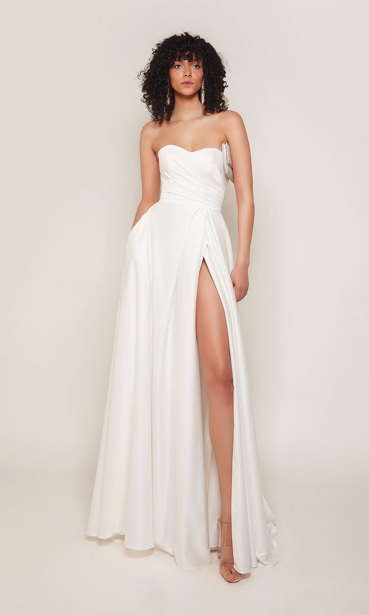A woman models the Alyce 7088 Long Formal Dress, featuring a strapless sweetheart neckline and high thigh slit, set against a plain light background.