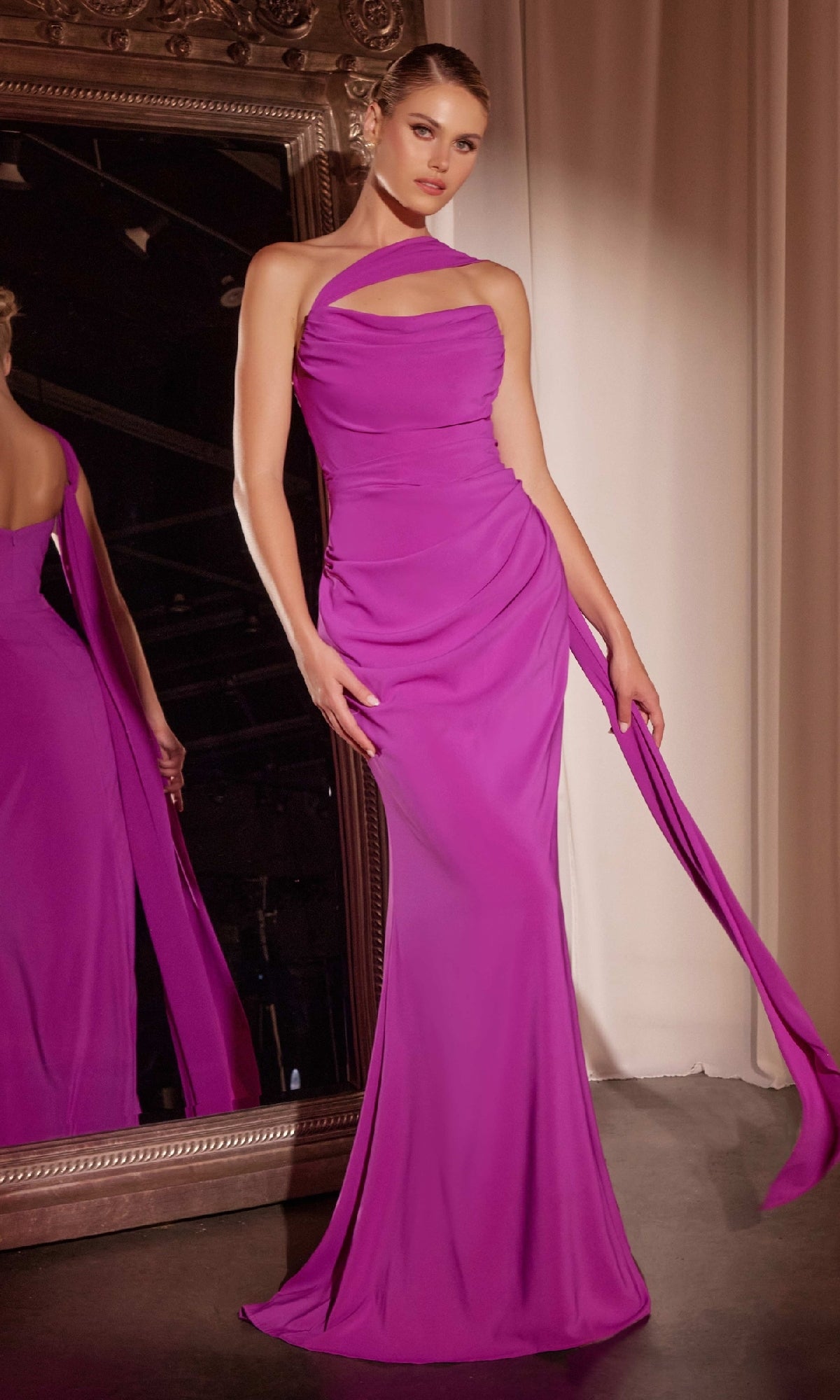 A woman in the Ladivine 7433 Multi-Way Long Chiffon Prom Dress, styled with a fitted floor-length magenta silhouette and single shoulder strap, stands before a large ornate mirror.