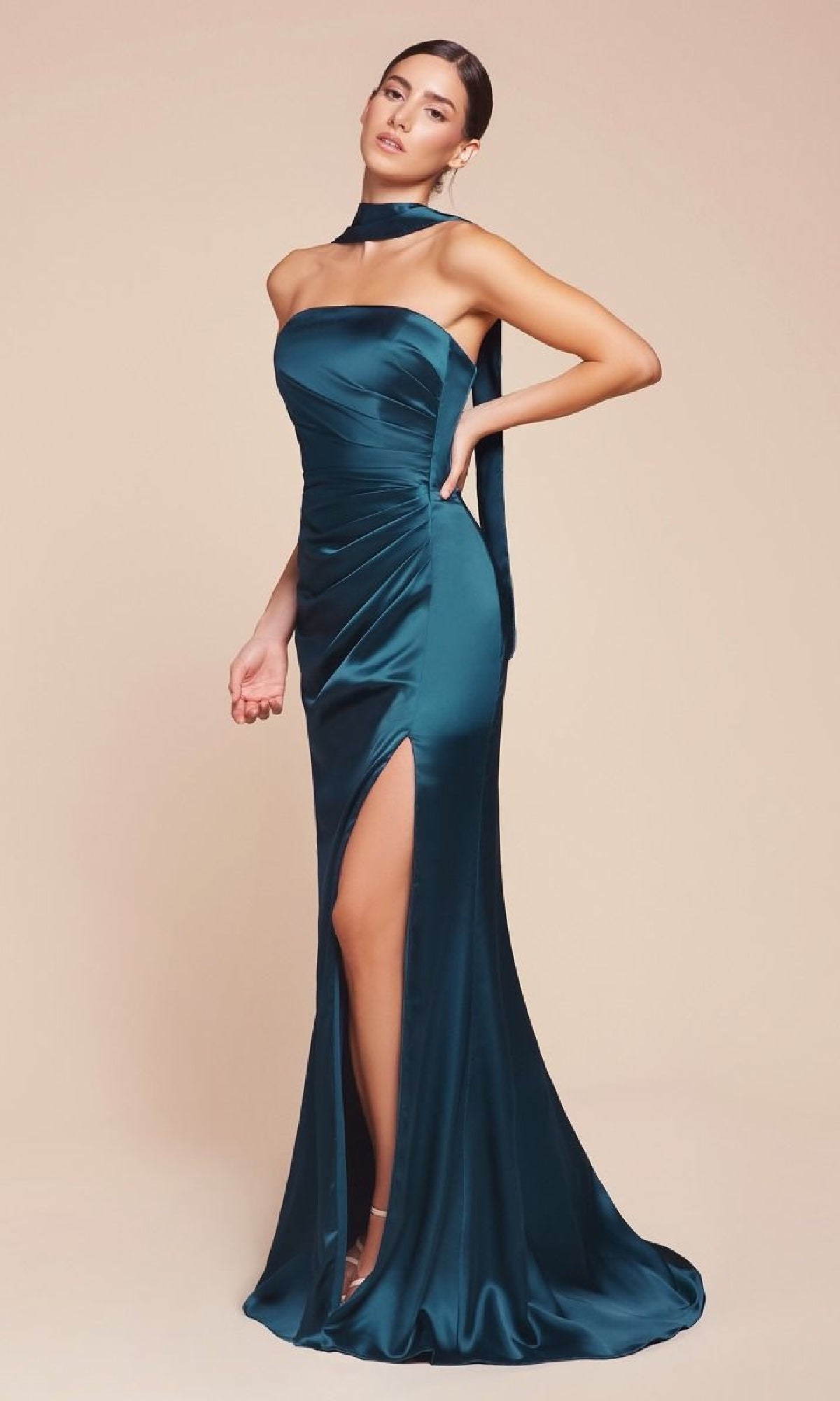 A woman poses against a beige background wearing the Ladivine 7451 Simple Strapless Long Prom Dress in dark teal satin, featuring a high slit, fitted silhouette, and a matching neck scarf.
