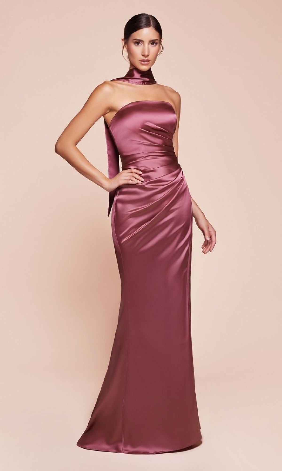 A woman models the Simple Strapless Long Prom Dress: Ladivine 7451—a mauve, floor-length satin gown with a fitted bodice and matching neck scarf—posing against a light pink background.
