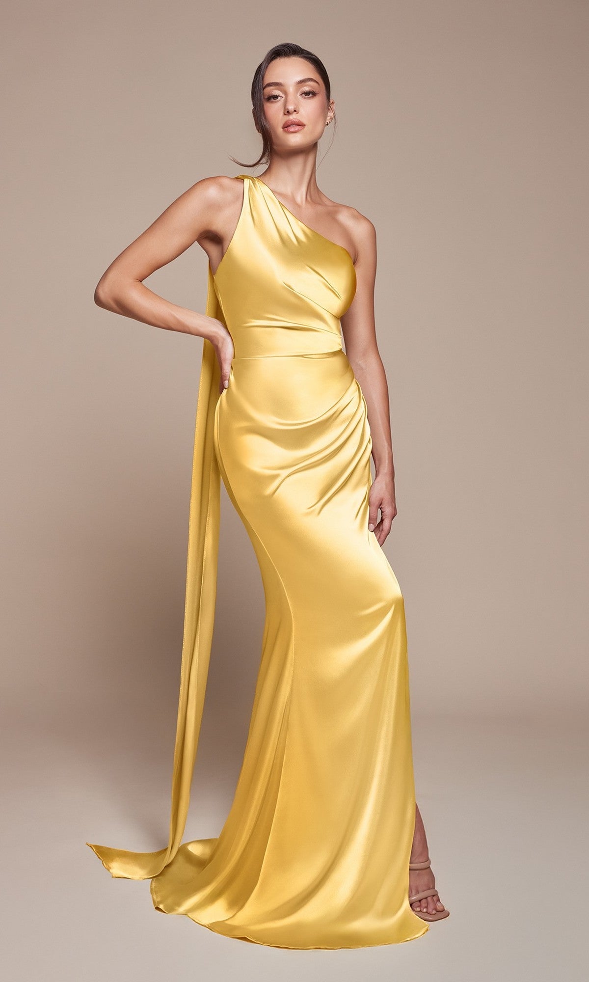 Against a neutral background, a woman poses in the One-Shoulder Sash Long Prom Dress (Ladivine 7454), a floor-length satin formal gown featuring an elegant draped sash.