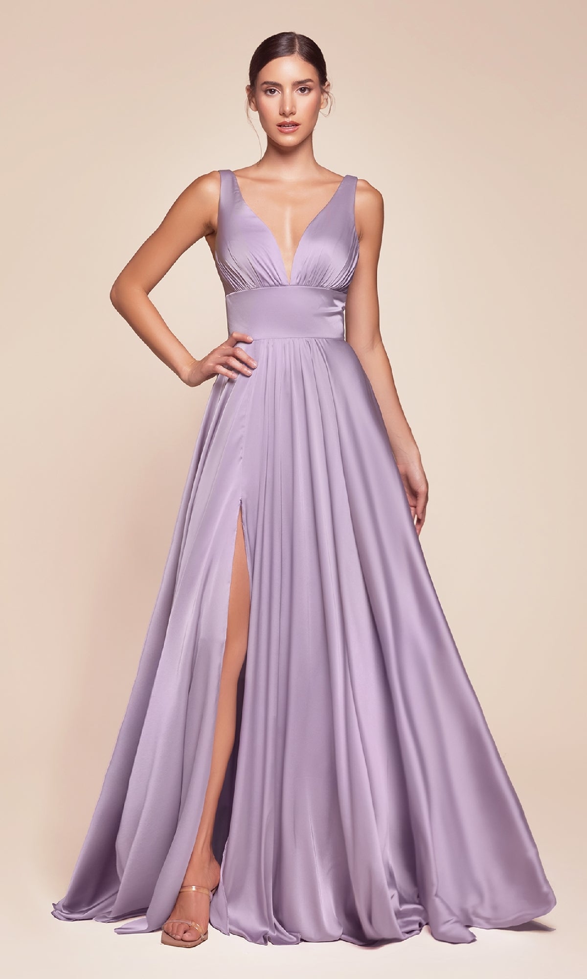 A woman in the Ladivine 7469 sleeveless classic long prom dress, featuring a deep V-neckline and high leg slit in lavender satin, stands against a plain light background.