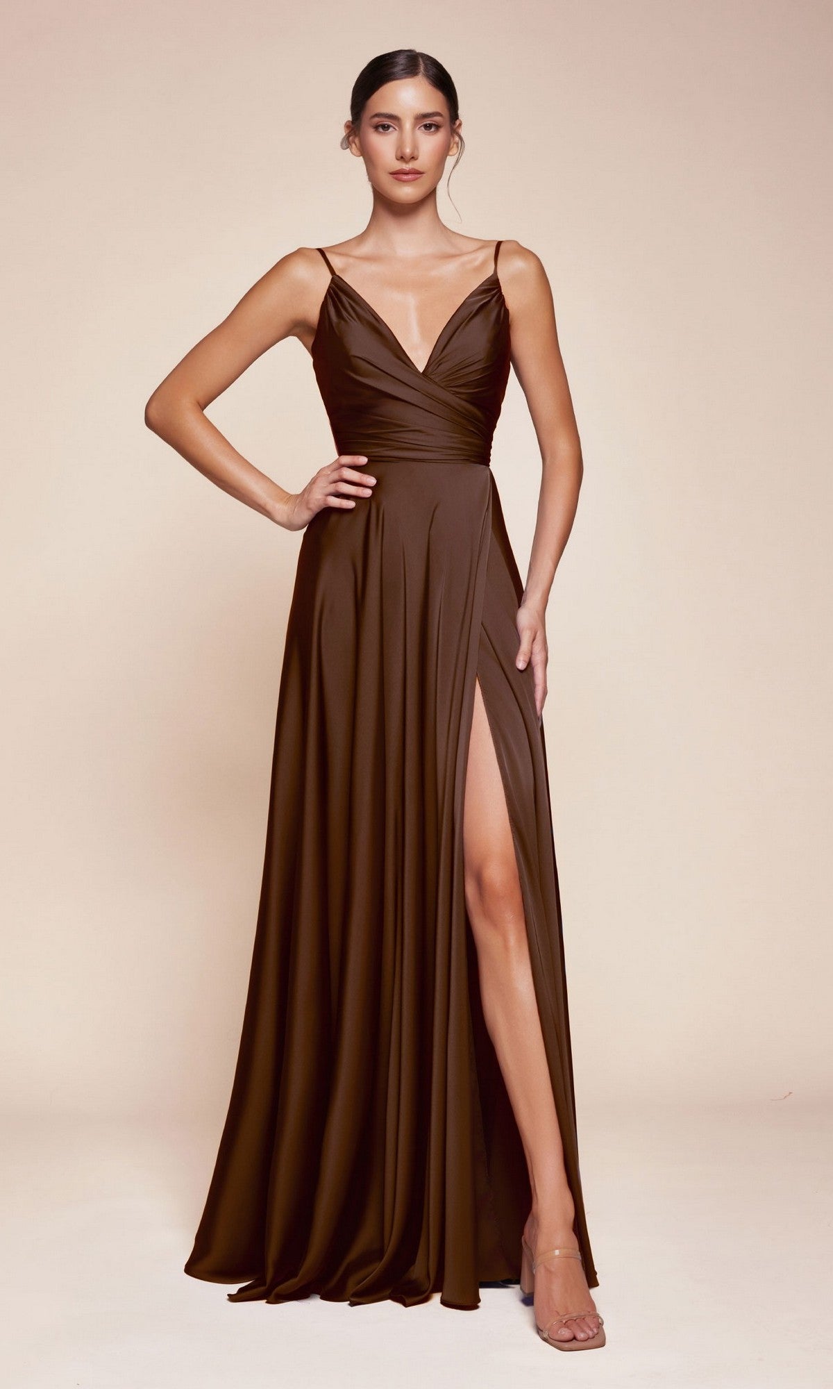 A woman poses with one hand on her hip in the Ladivine 7485 Classic Long Satin Formal Prom Dress, a sleeveless floor-length gown with a thigh-high slit, set against a neutral background.