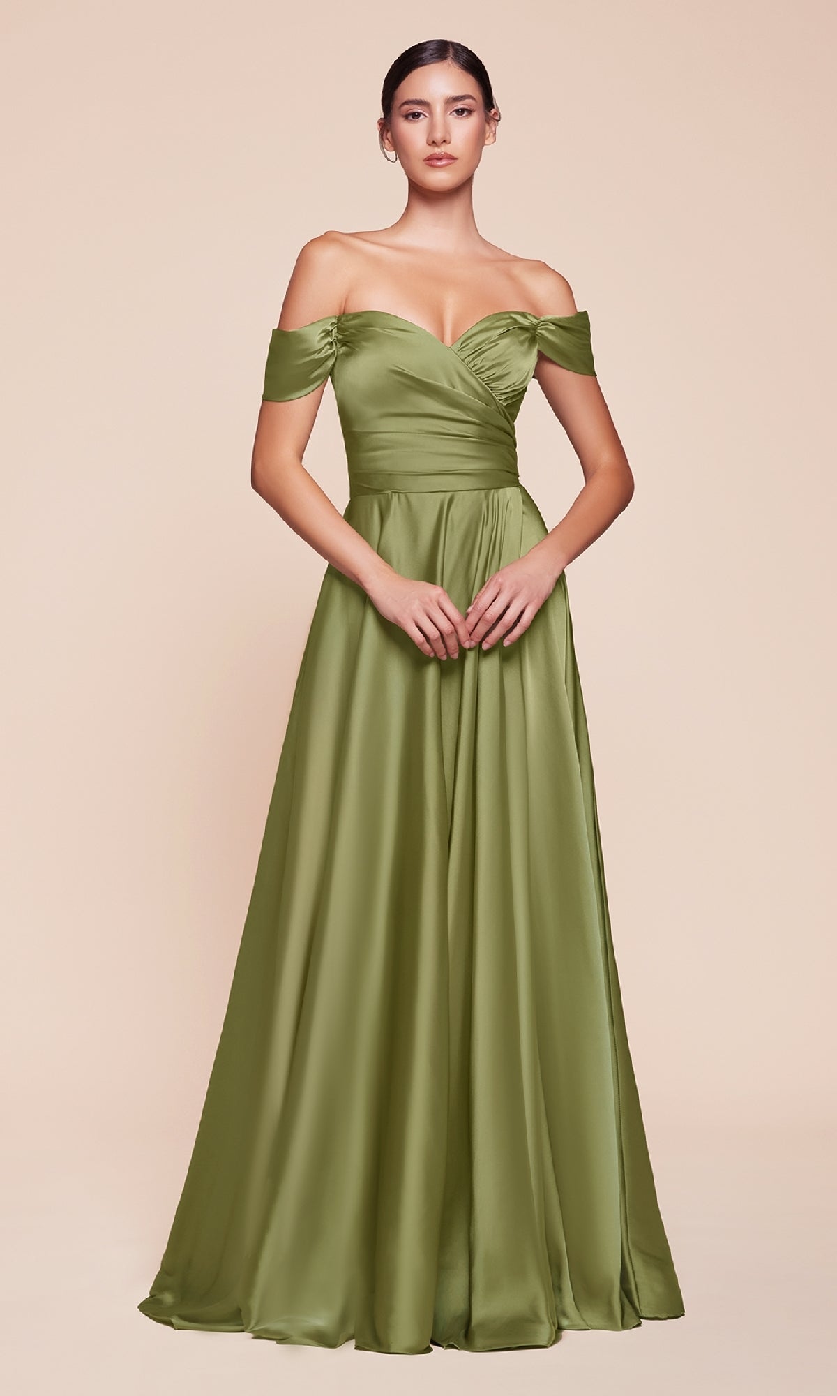 A woman models the Ladivine 7493-1 off-the-shoulder long prom dress in olive green satin, featuring a fitted bodice and flowing A-line skirt, standing against a beige background.