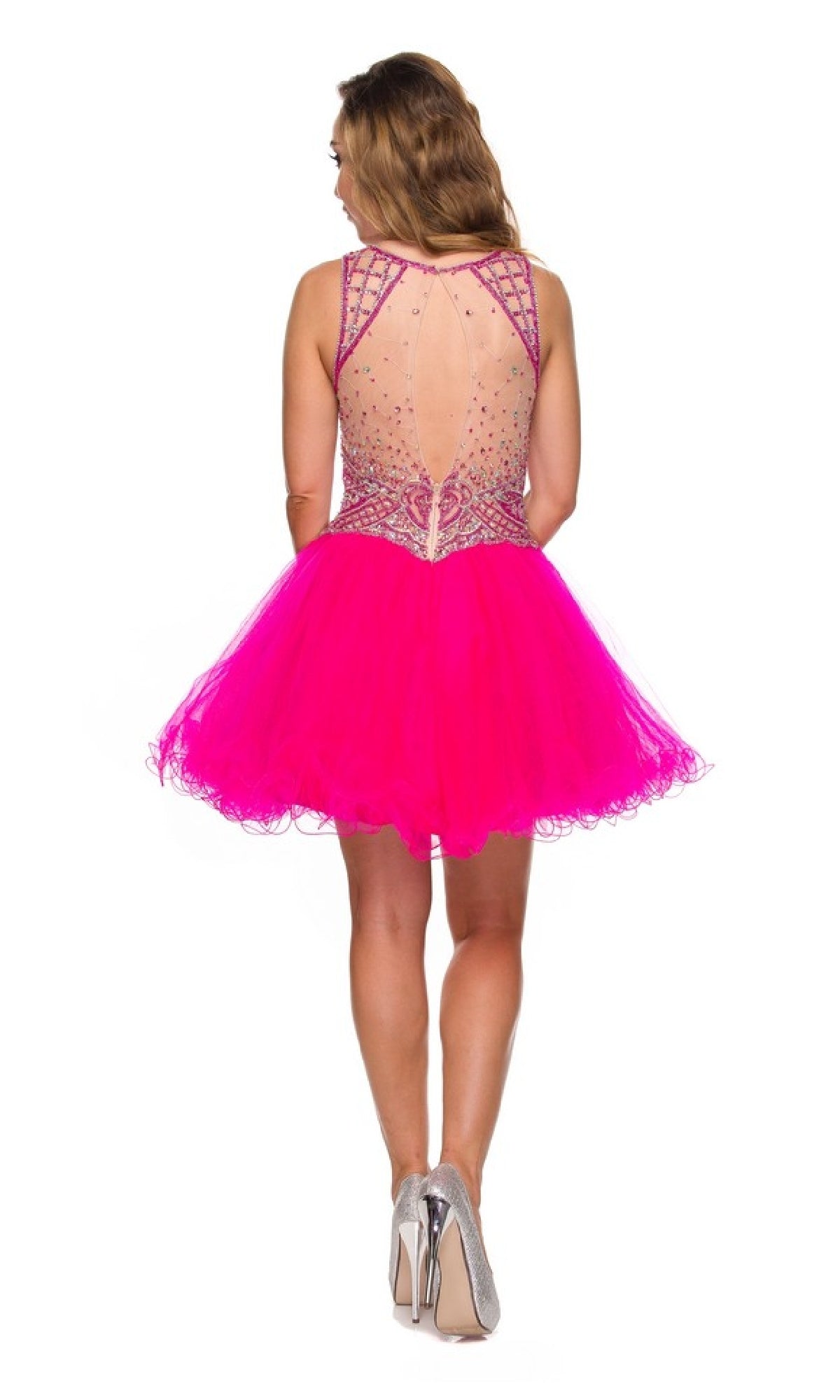 A woman faces away, wearing the Juliet 761 short party dress—hot pink, sleeveless, with a sheer beaded back and an A-line tulle skirt—paired with silver heels.