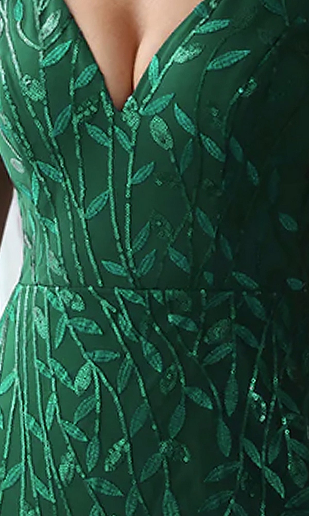 Close-up of the V-Neck Long Formal Dress with Embroidery 7886, featuring a green hue, deep neckline, and shiny embroidered leaf pattern—ideal for an elegant evening gown look.