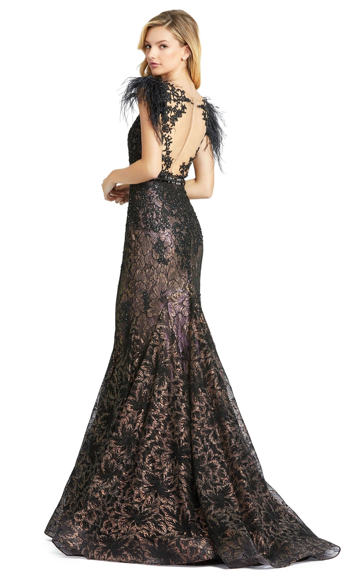A woman wearing the Mac Duggal 79230 Feathered Long Lace Formal Dress, featuring black lace, feathered shoulders, a low back, and a floor-length flared skirt.
