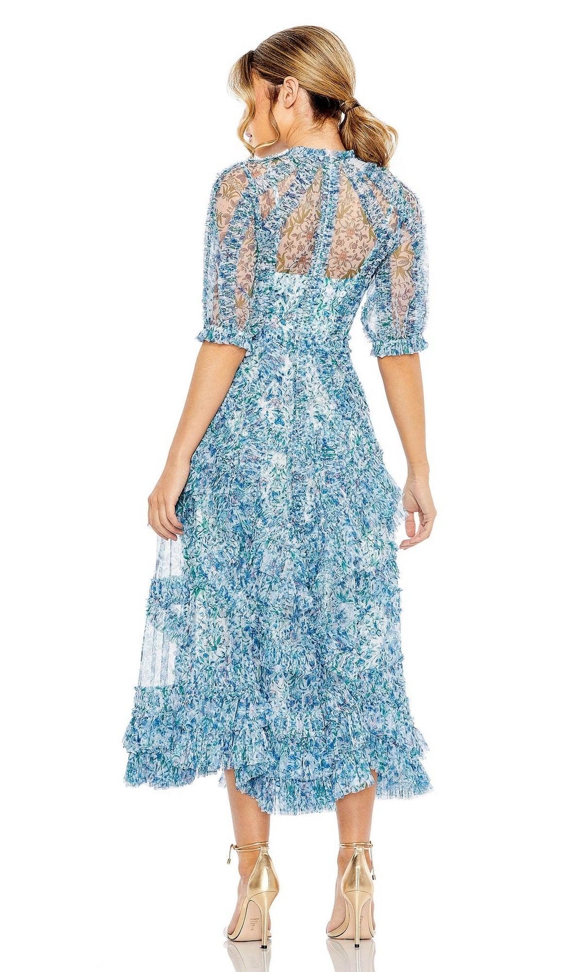 Woman facing away, wearing the Midi Wedding Guest Dress 8011 by Mac Duggal—a blue floral midi dress with sheer sections and ruffled hem—an elegant choice paired with nude strappy heels.