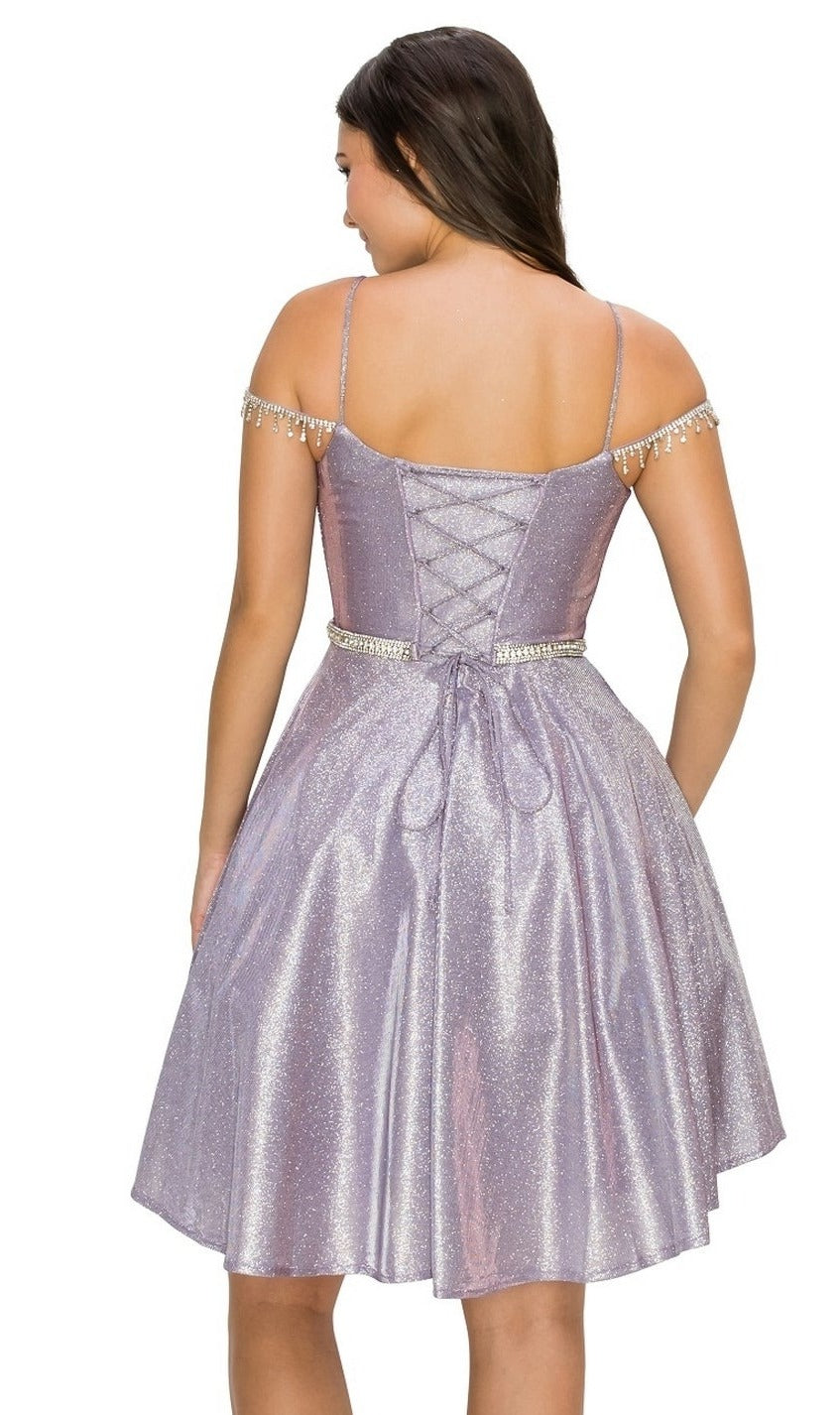 A woman is shown from behind wearing the Beaded Cold-Shoulder Short Homecoming Dress 8014J, featuring a shimmering lavender fabric, pearl accents, spaghetti straps, and a lace-up back.