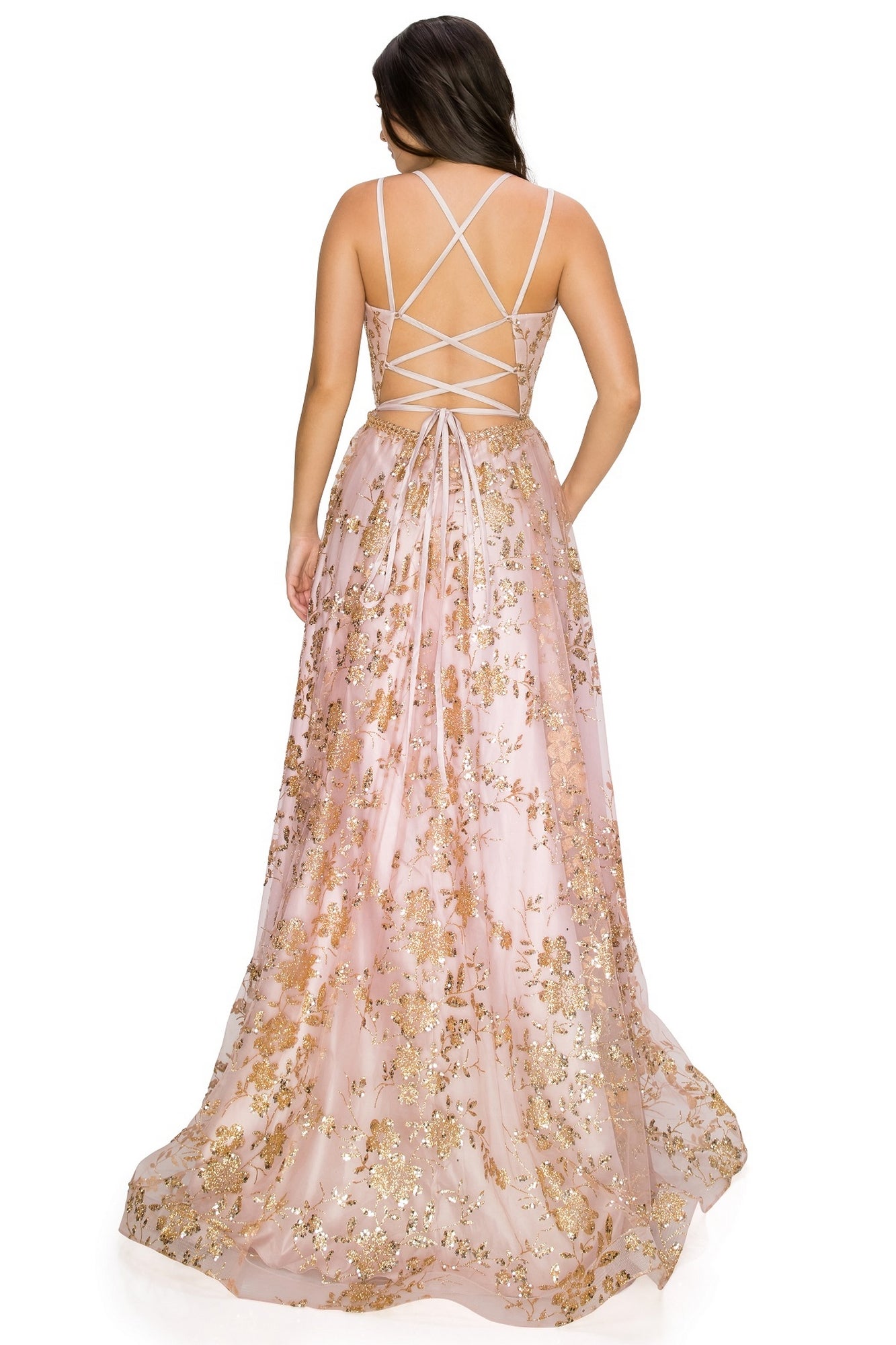 Woman facing away, wearing the Floral-Glitter Long A-Line Formal Prom Dress 8022J—a light pink gown with gold floral patterns, a long skirt, and crisscross straps on the open back.