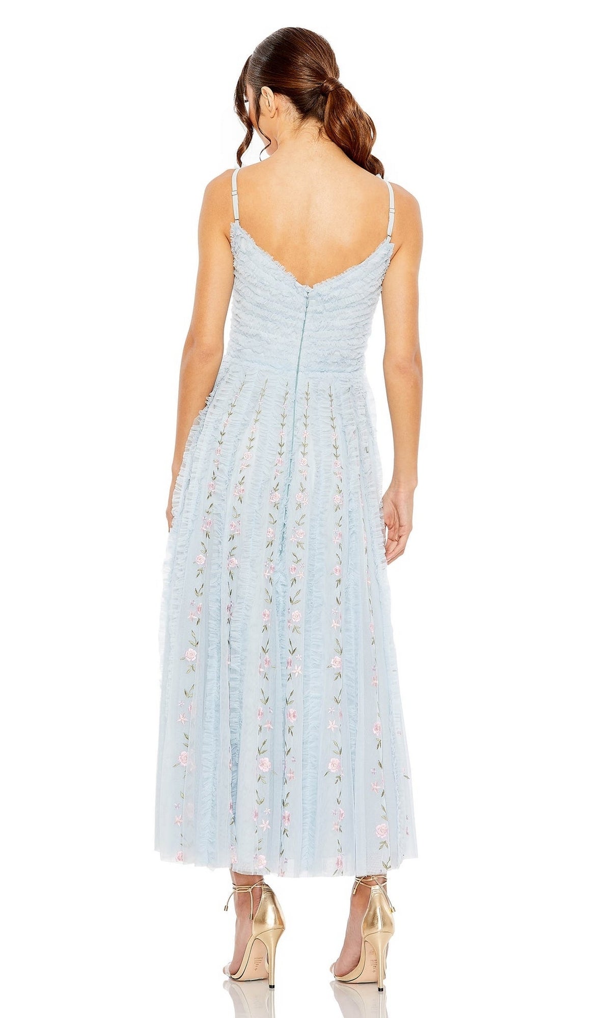 A woman models the Midi Wedding Guest Dress 8027 by Mac Duggal, a pastel blue ankle-length dress with thin straps and floral embroidery, seen from the back with high-heeled shoes.