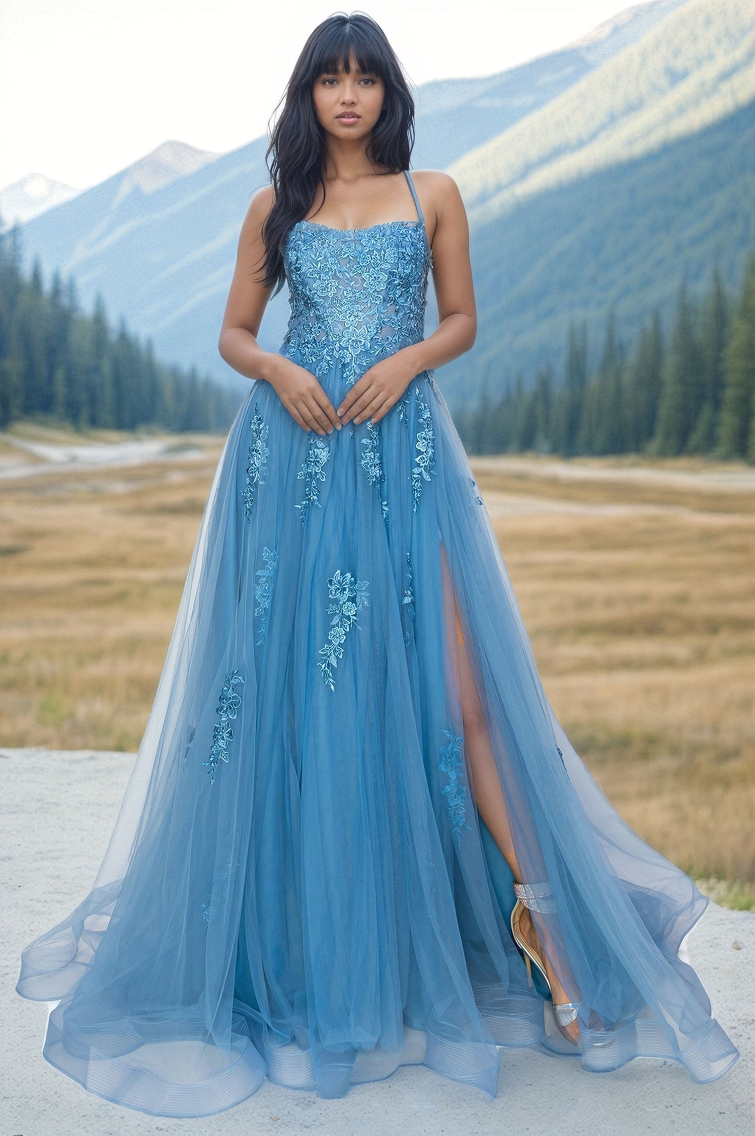 A woman stands outdoors before mountains, wearing the Floral-Embroidered Long Tulle Prom Dress 8031J featuring a thigh-high slit.