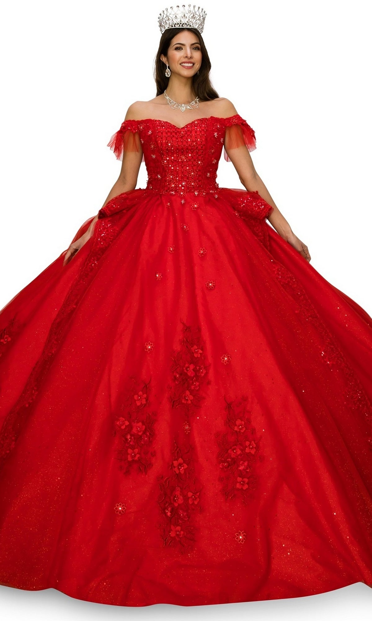 A woman smiles and stands with arms slightly extended, wearing the Quinceanera Dress 8055J By Cinderella Couture—a sparkling red off-the-shoulder ball gown adorned with lace embroidery, floral details, and a crown atop her head.