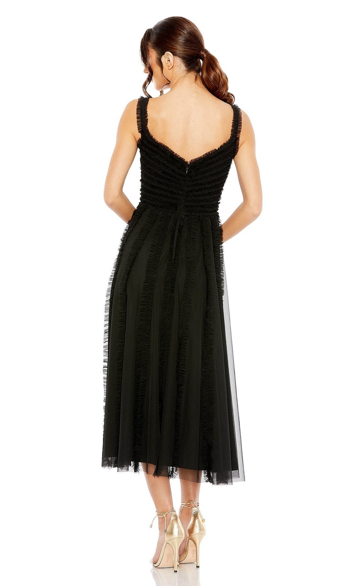 A woman stands with her back to the camera, wearing the Mac Duggal 8056 Ruffled Midi Wedding Guest Dress in black and high-heeled shoes. Her hair is styled in a ponytail.