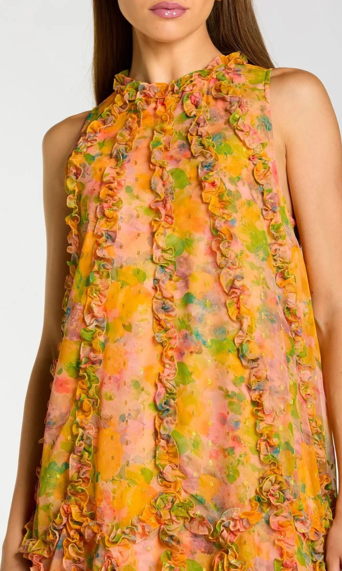 A woman wearing the Mac Duggal 8103 Midi Wedding Guest Dress—a sleeveless, ruffled floral chiffon dress with a high-low hemline in vibrant yellow, orange, green, and pink—perfect for attending weddings.