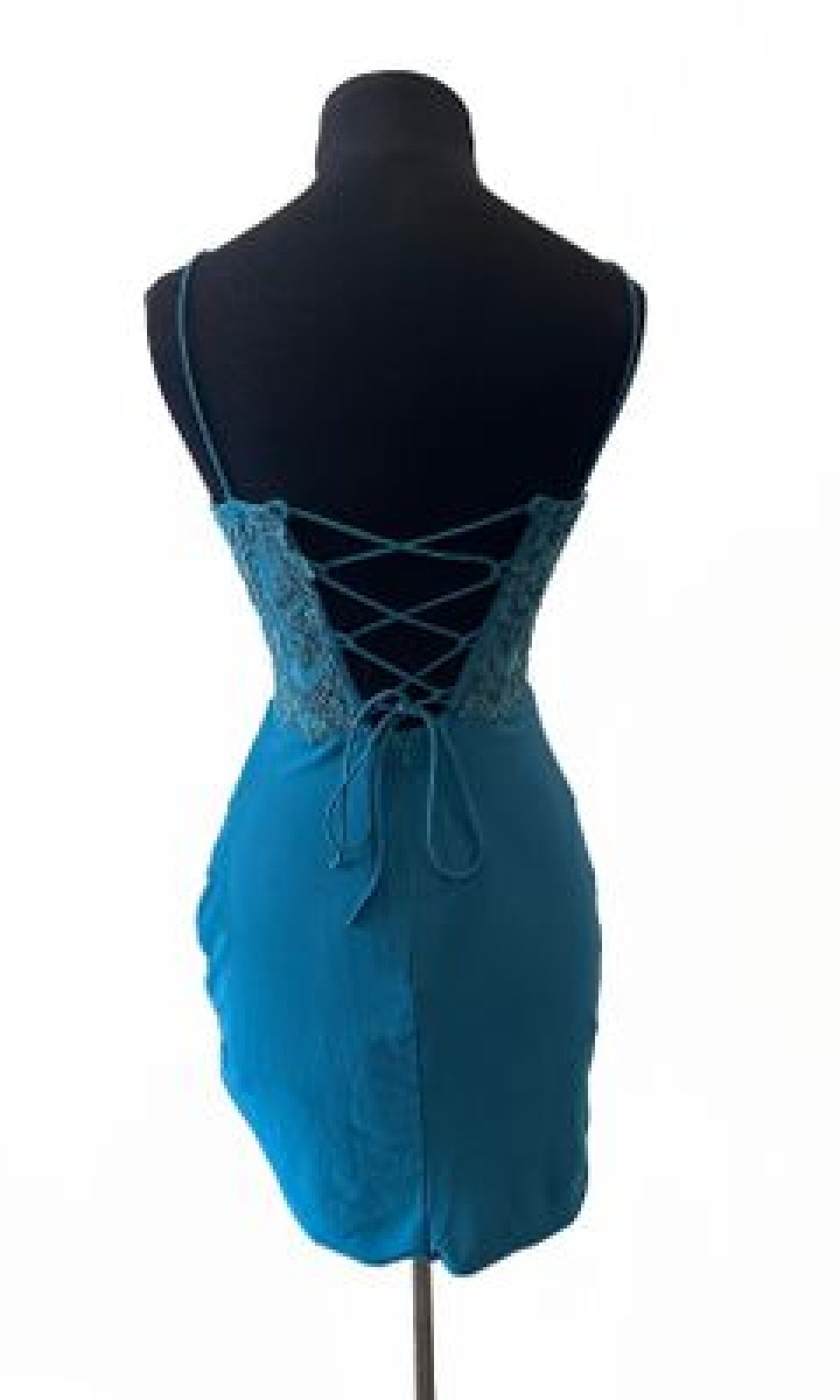 The Aerie Couture 823 Lace-Up Short Homecoming Dress features teal satin, lace details, and crisscross lacing on the open back, shown on a black dress form against a white background.