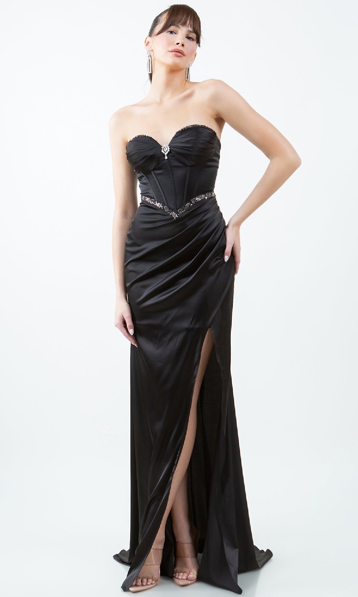 A woman models the Strapless Long Prom Gown: Cinderella Couture 8259J, featuring a sweetheart neckline, jeweled belt, corset-style bodice, and thigh-high slit, standing against a plain white background.