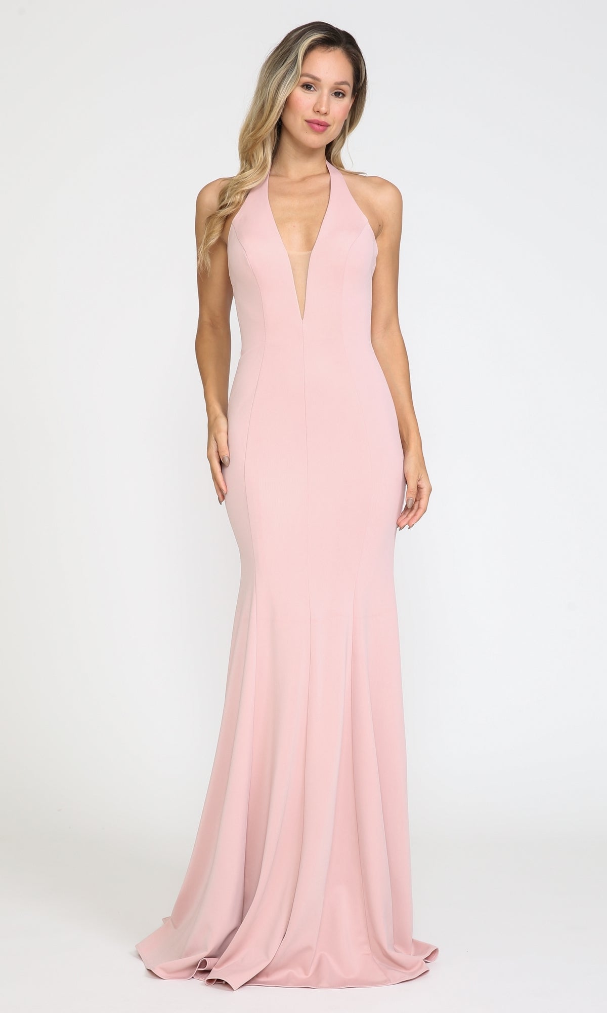 A woman stands against a plain background wearing the Halter V-Neck Long Jersey Formal Prom Dress 8262 in rose gold, featuring a sleeveless, floor-length design with a deep V-neckline.