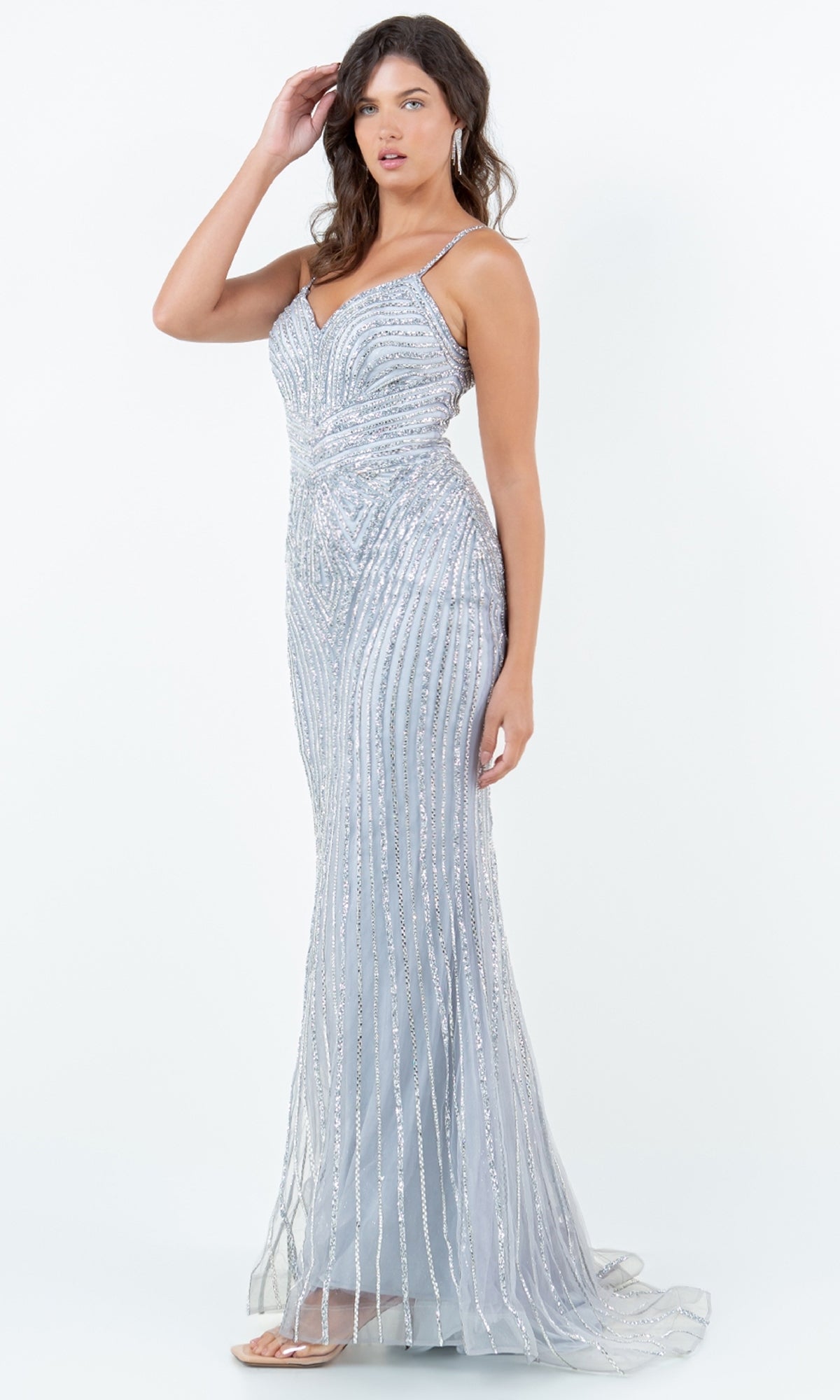 A woman models the Cinderella Couture 8268J—a light blue, floor-length prom dress with thin straps, a sweetheart neckline, and silver sparkly beading—against a plain white background.