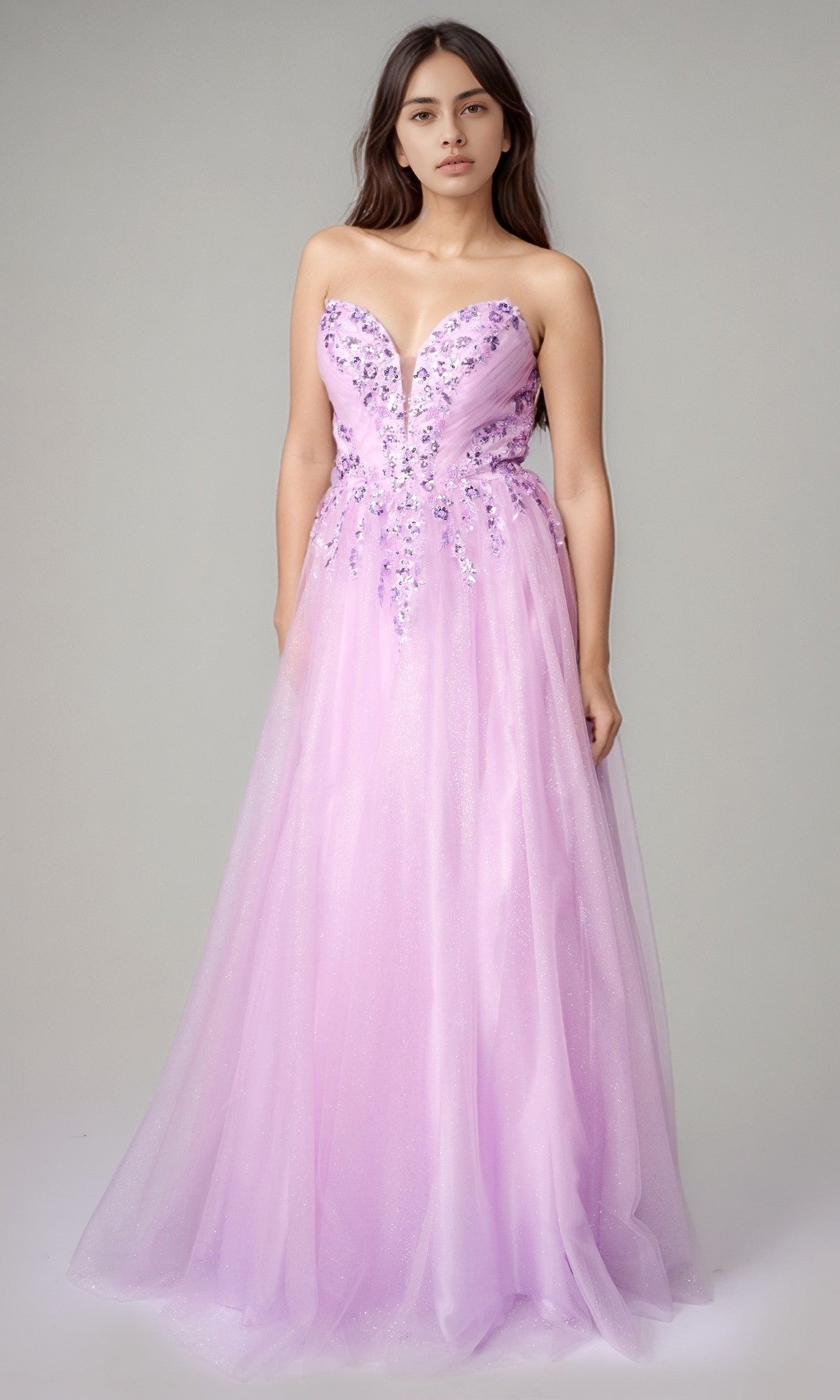 A woman stands against a plain background wearing the Nina Canacci 8310, a long formal lilac dress with a strapless sweetheart neckline and floral-embellished bodice.