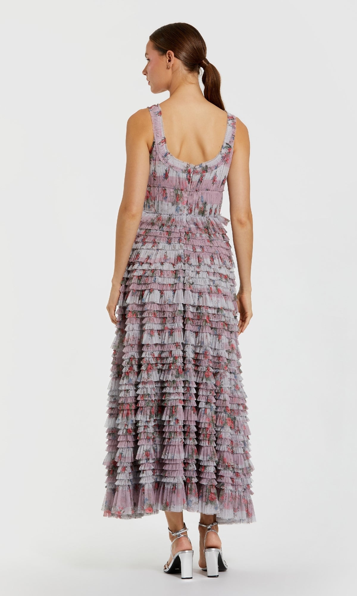 Woman wearing a patterned dress on a white background