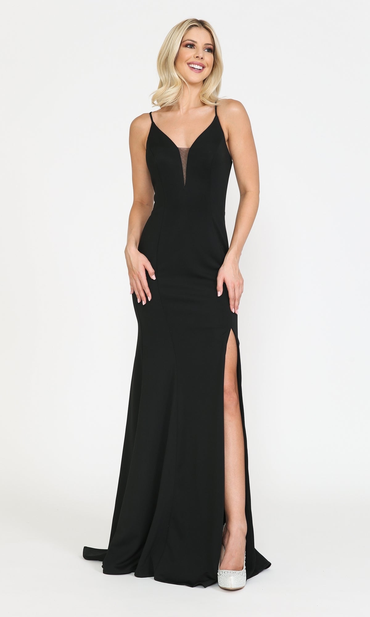 Woman wearing the Open-Back V-Neck Long Simple Jersey Prom Dress 8360 in black, a sleeveless floor-length gown with a high slit, posing and smiling against a plain white background.