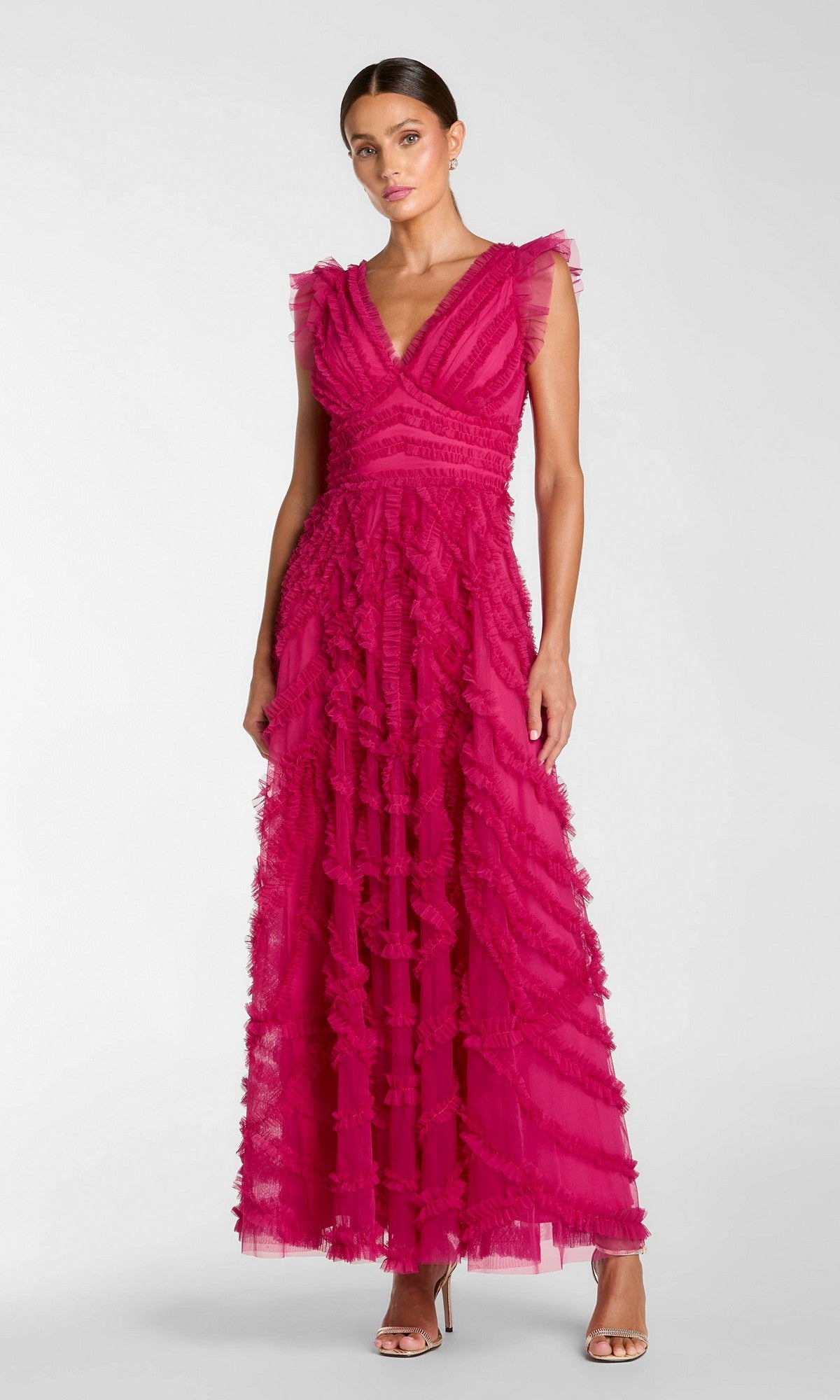 A woman stands in heels against a plain background wearing the Mac Duggal 8498 long formal dress in fuchsia—a sleeveless, floor-length gown featuring ruffled tulle details and an elegant A-line silhouette.