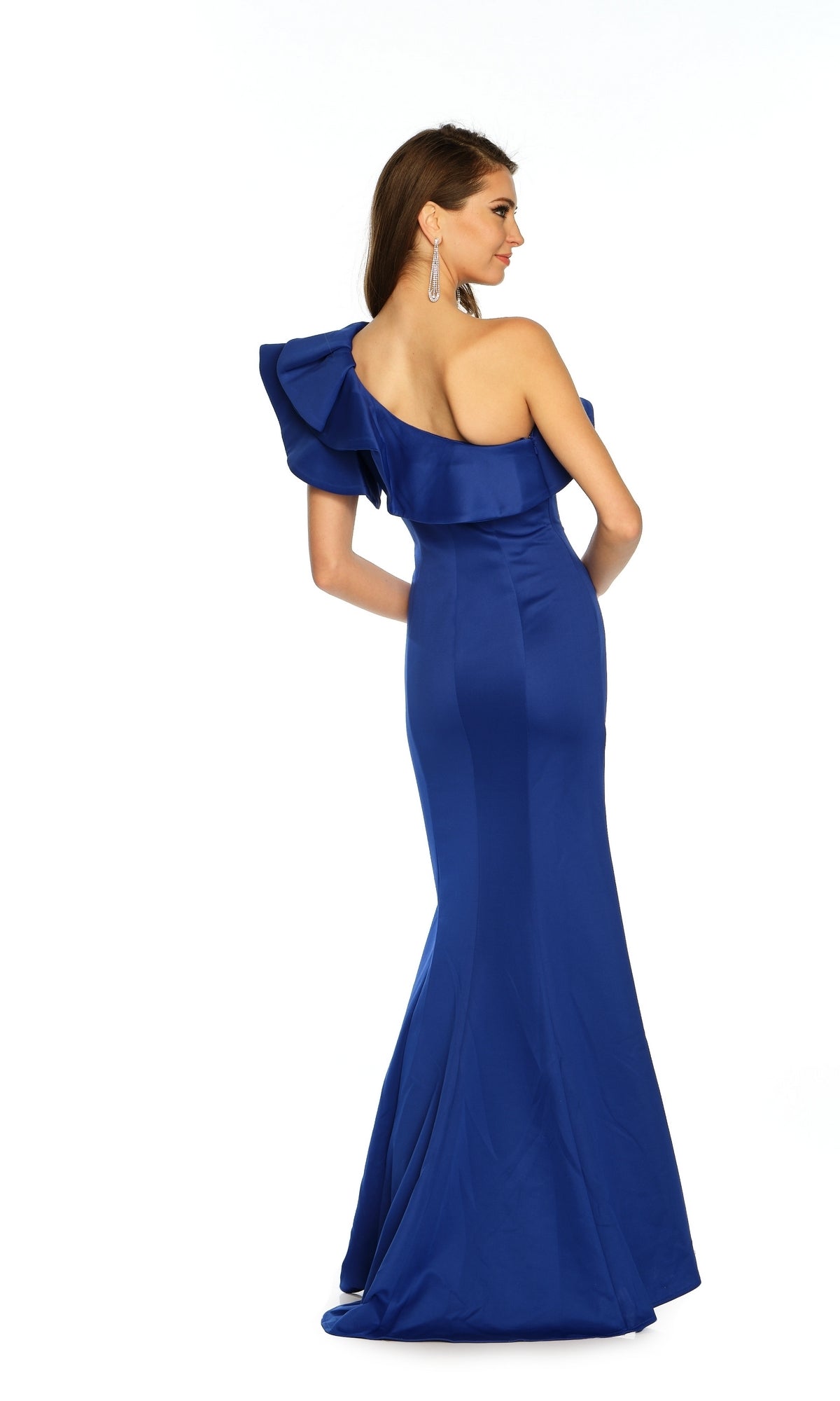 A woman models the Long Formal Dress A8568 by Dave and Johnny—a royal blue, one-shoulder fitted gown with a ruffled bodice—looking over her shoulder against a plain white background.