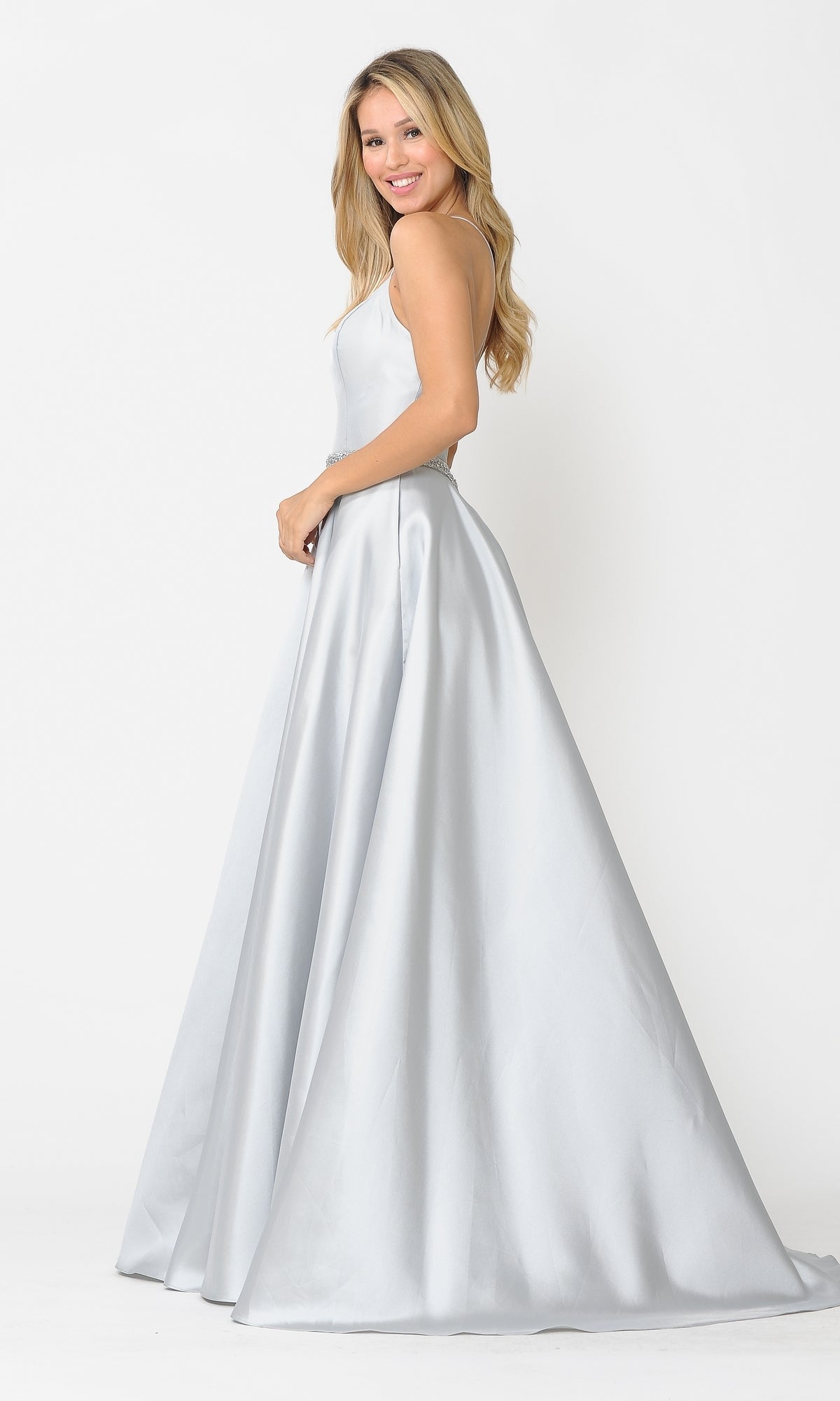 A woman with long blonde hair wears the Scoop-Neck Long A-Line Prom Dress with Pockets 8684, standing and smiling against a plain white background.