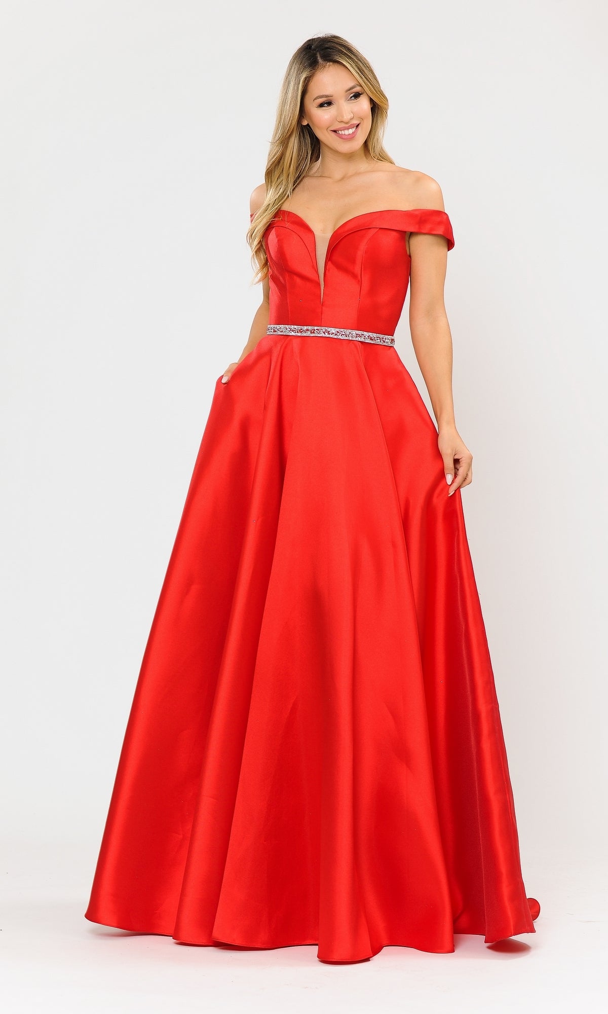 A woman models the Off-the-Shoulder Long Prom Gown with Pockets 8686 in bold red Mikado, featuring a deep V-neckline and jeweled belt, posed against a plain white background.