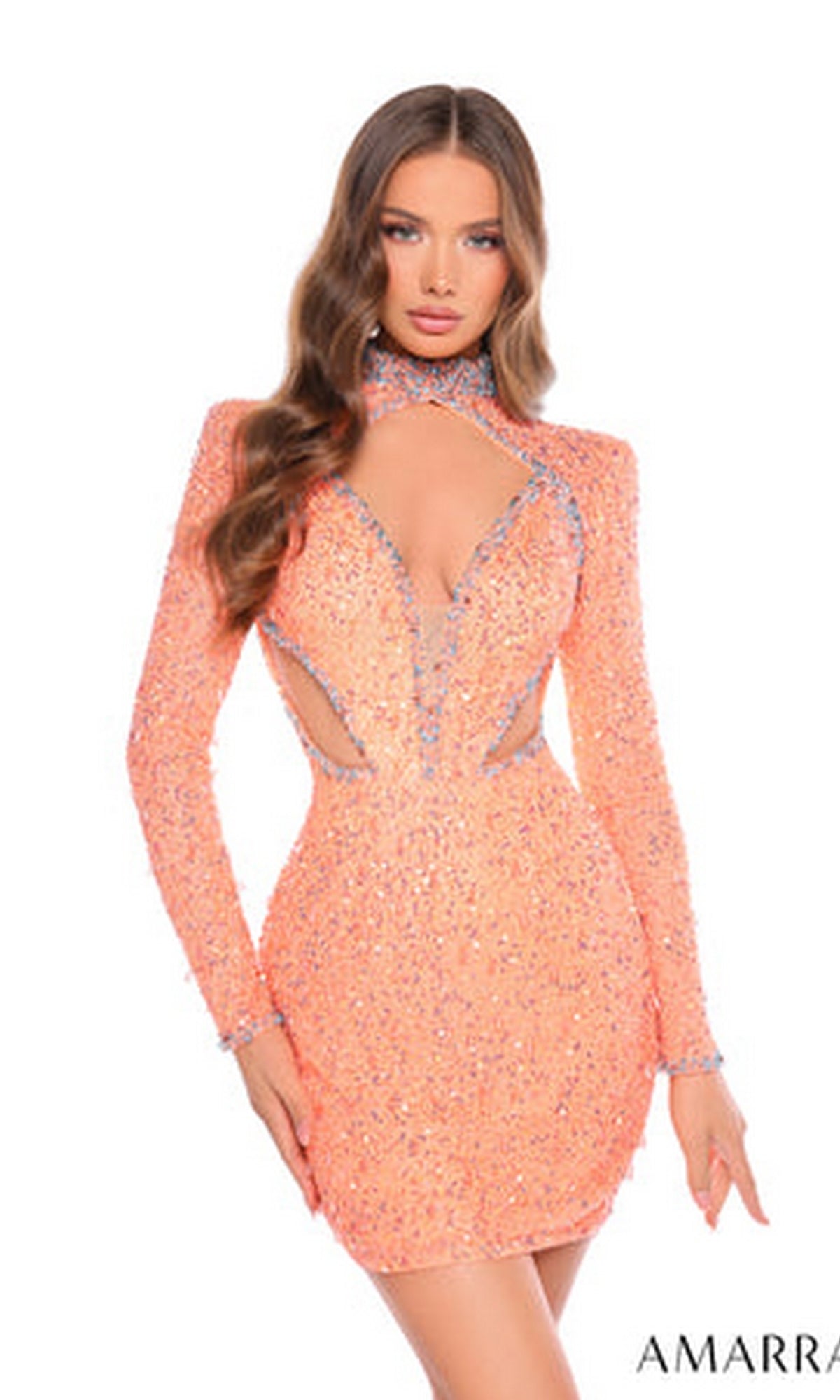 A woman poses against a white background wearing the Short Homecoming Dress 88020 by Amarra—a peach, form-fitting mini dress with long sleeves, cut-outs, silver embellishments, and an open back.