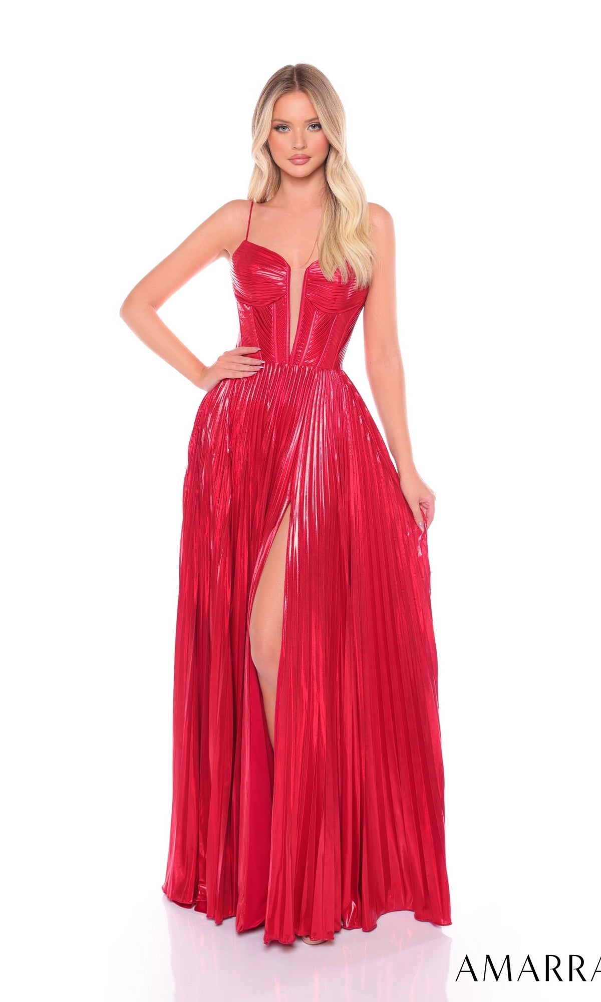 A woman stands against a white background wearing the Long Formal Dress 88098 by Amarra—a shiny red pleated A-line dress with spaghetti straps, a boned corset bodice, and a thigh-high slit.