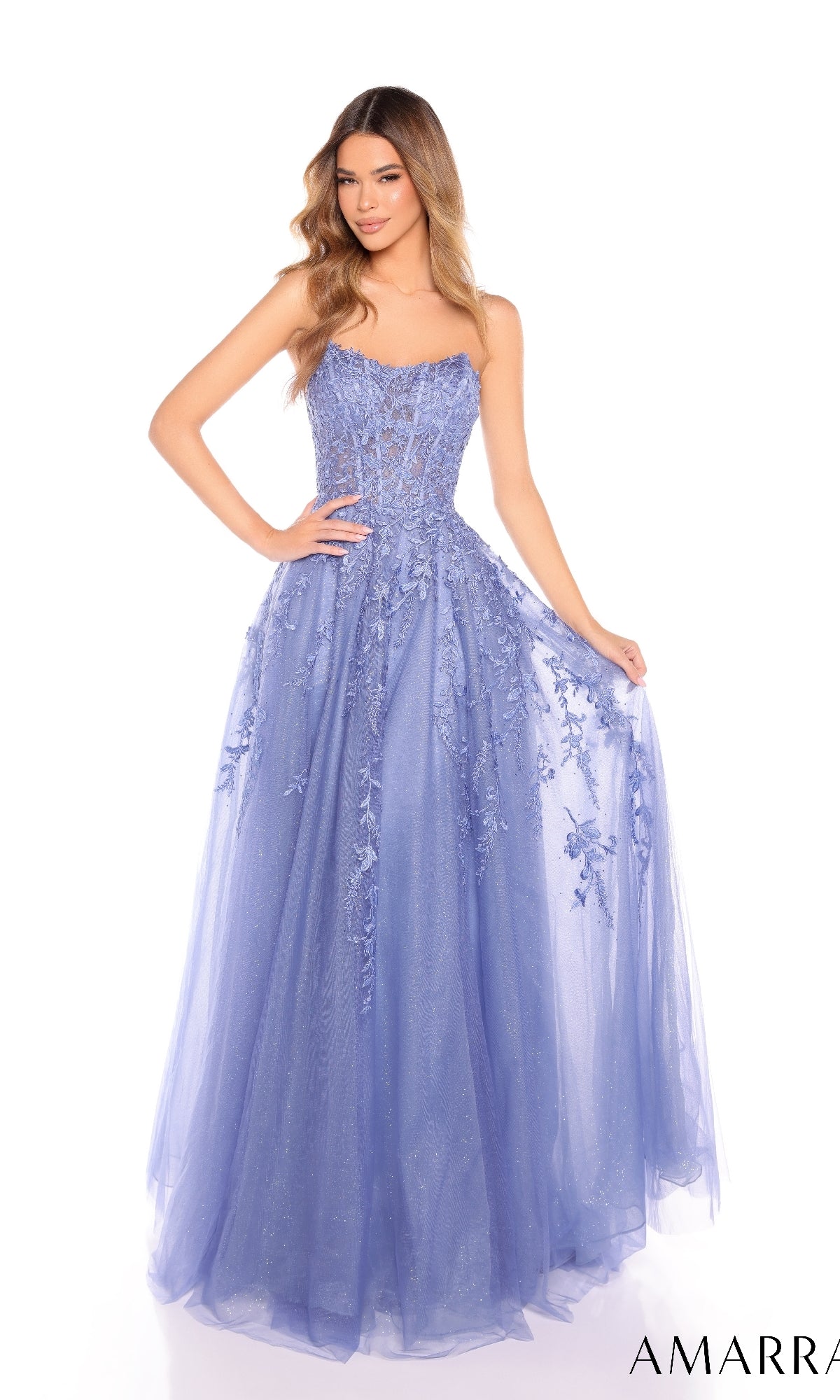 A woman in the Amarra 88258 long prom dress stands holding the sides of her lavender, floor-length skirt, featuring a strapless design with a sheer corset bodice and floral embroidery.