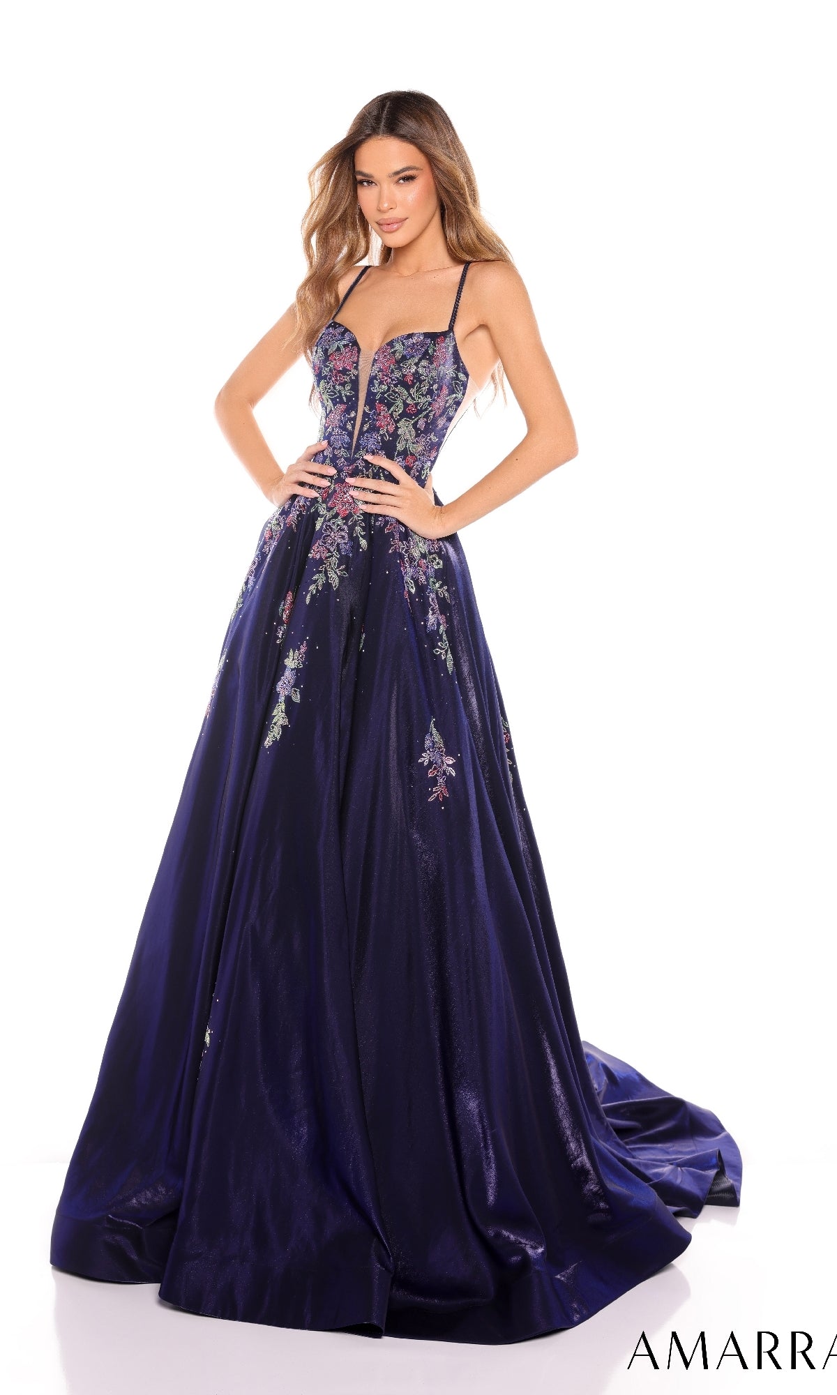 A woman poses with her hands on her hips against a white background, wearing the Amarra 88379 long prom dress?a deep purple, floor-length gown featuring floral embroidery and thin straps.