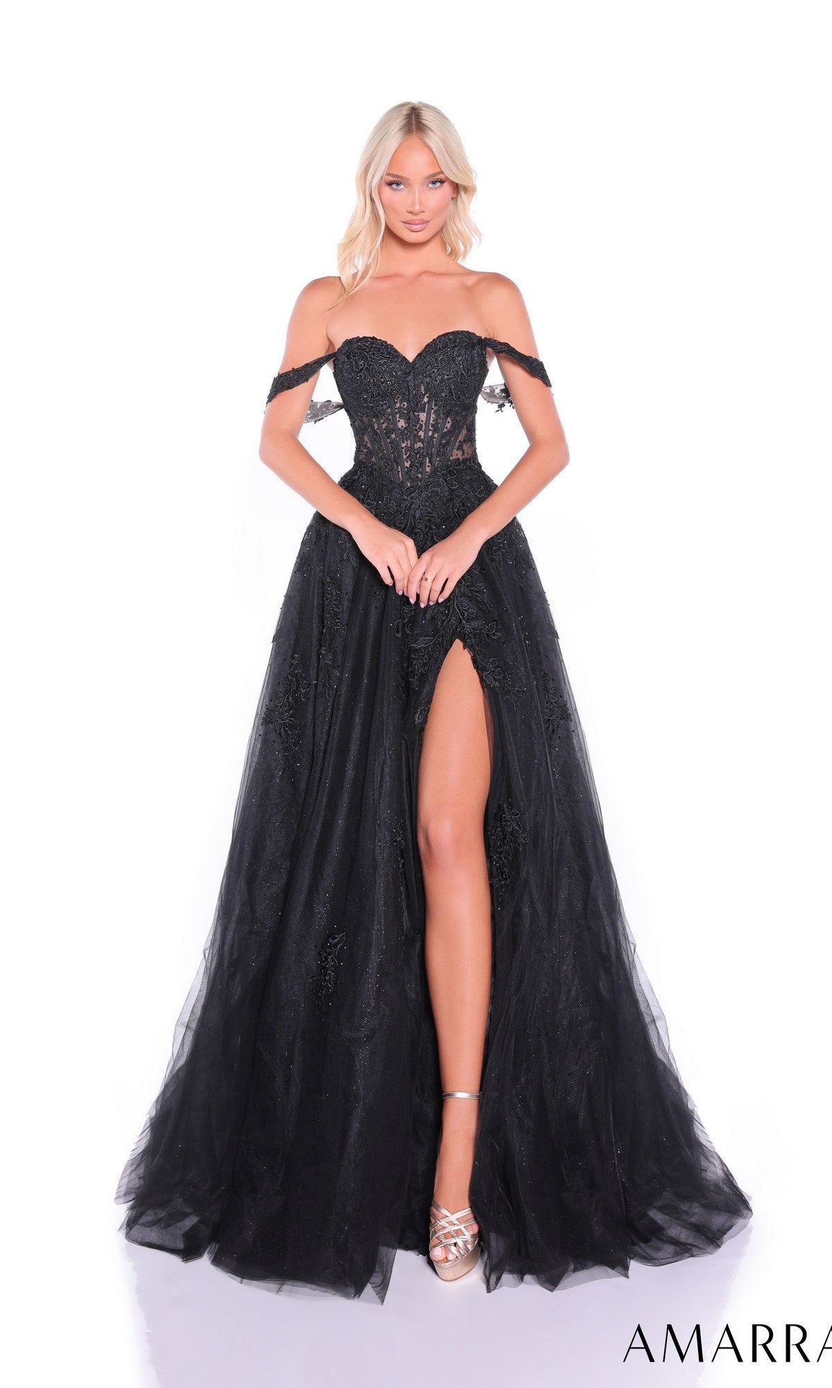 A woman stands against a white background wearing the Amarra 88963, an off-shoulder black prom ball gown featuring a sweetheart neckline, sheer corset bodice, and high slit.