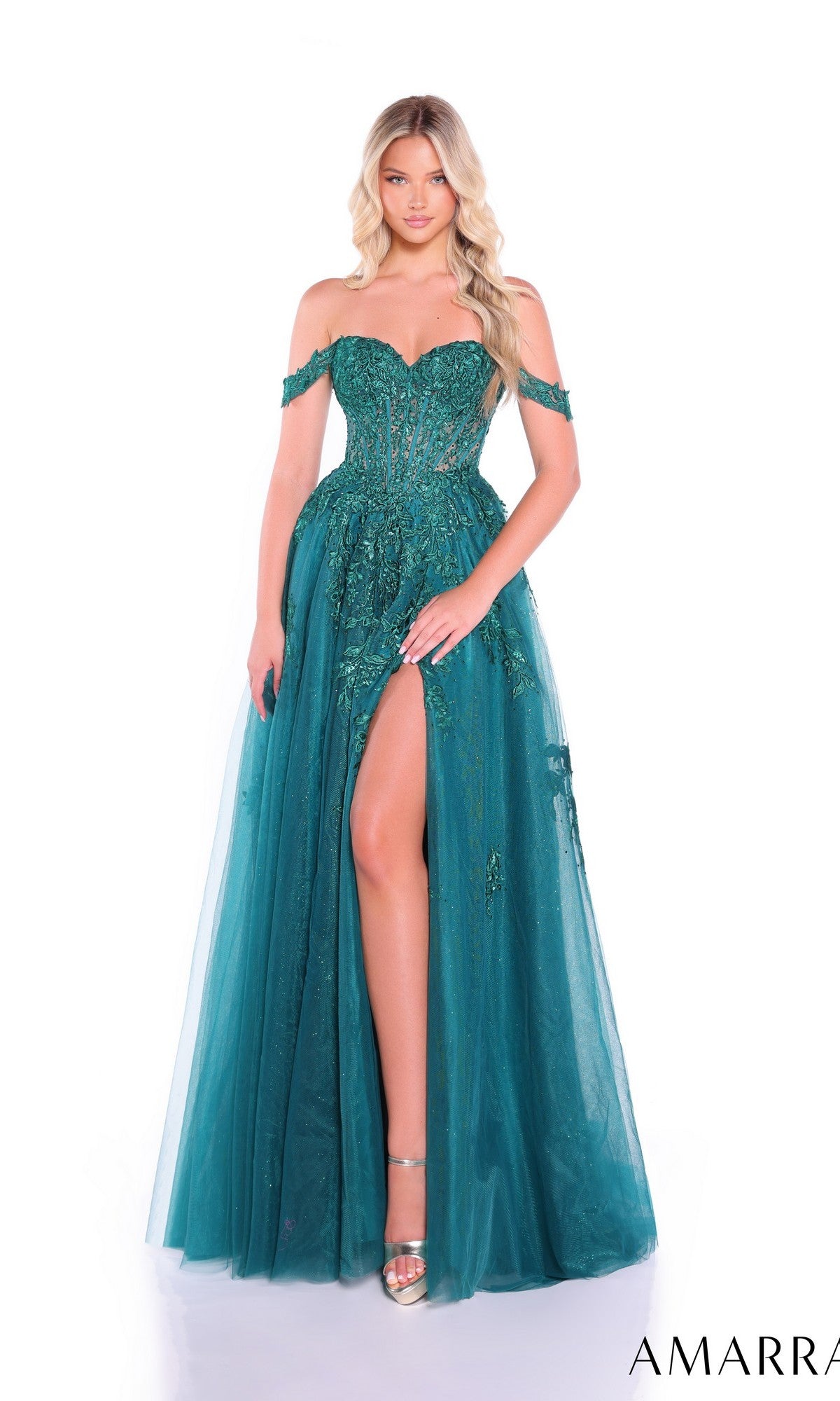 A woman stands against a white background in the Amarra 88963, an off-shoulder corset prom ball gown with sequin embellishments, a sheer bodice, teal floor-length skirt, and a high slit for added glamour.