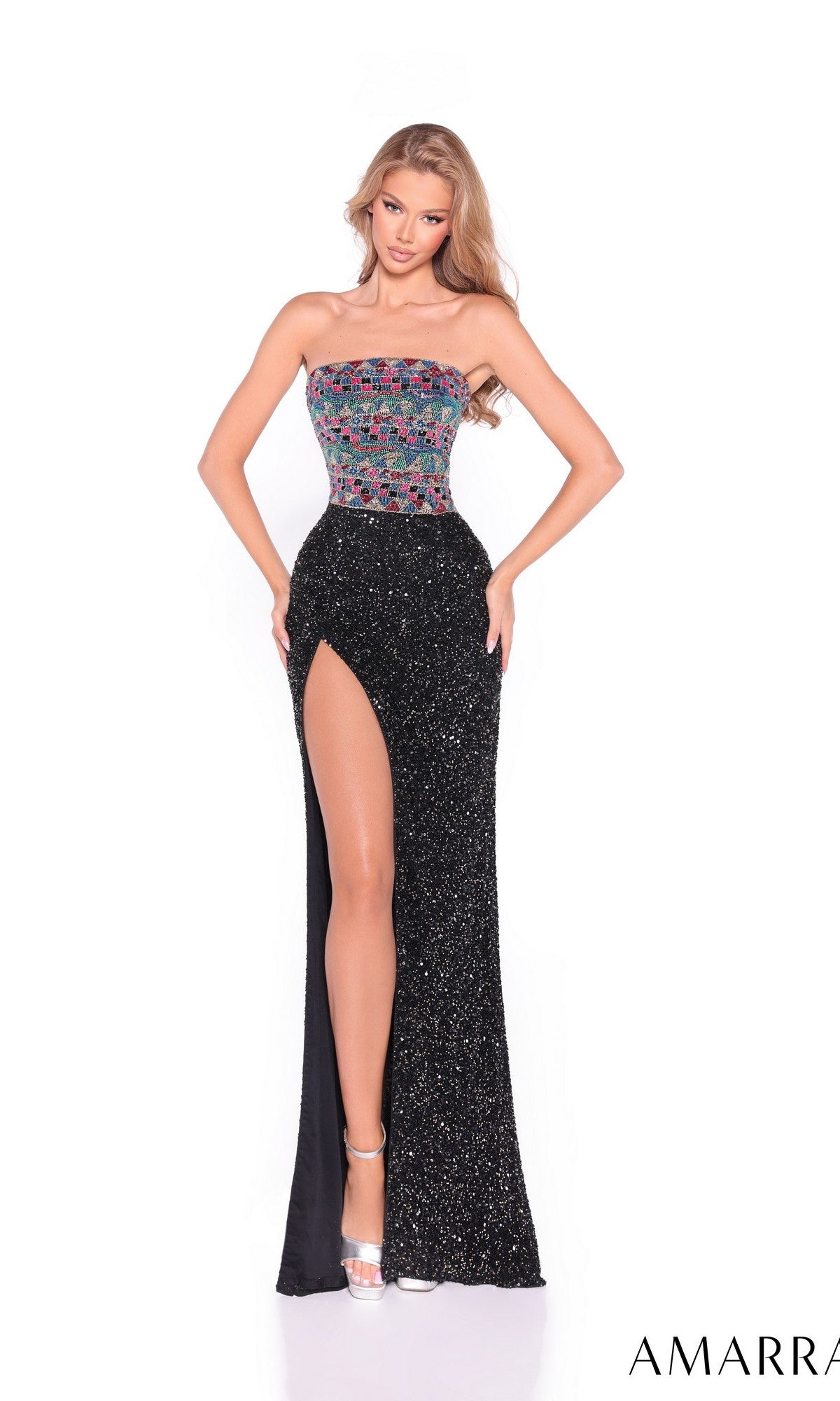 A woman models the Amarra 89073 long prom dress, featuring a strapless fitted design with a colorful beaded bodice and black glittery skirt with a thigh-high slit, standing against a plain white background.