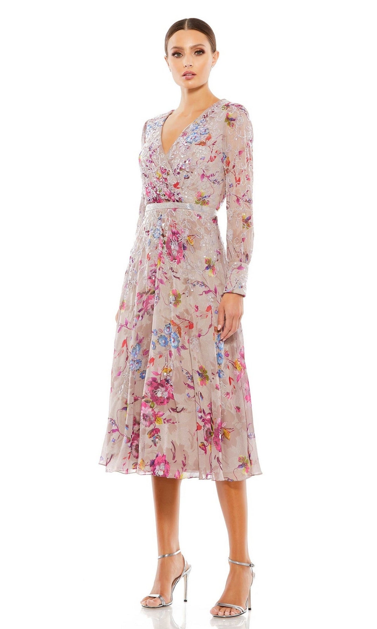 A woman wears the Mac Duggal 9147 Mauve Print Wedding Guest Dress with long sleeves and a V-neckline, paired with silver heels, standing against a plain white background.