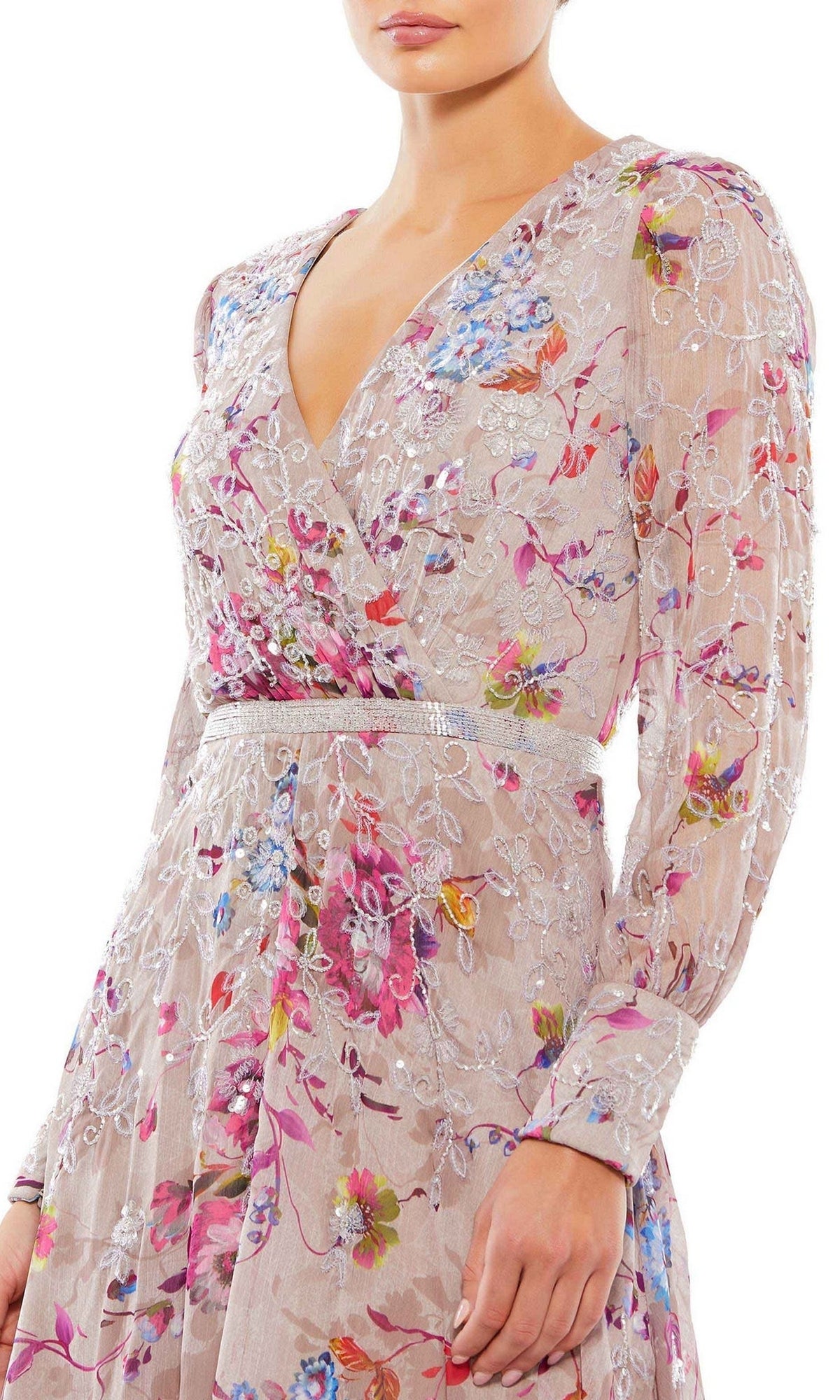 A woman wears the Mauve Print Wedding Guest Dress: Mac Duggal 9147, showcasing long sleeves, a V-neck, light pink color, colorful floral embroidery, and a fitted waist—perfect for weddings.