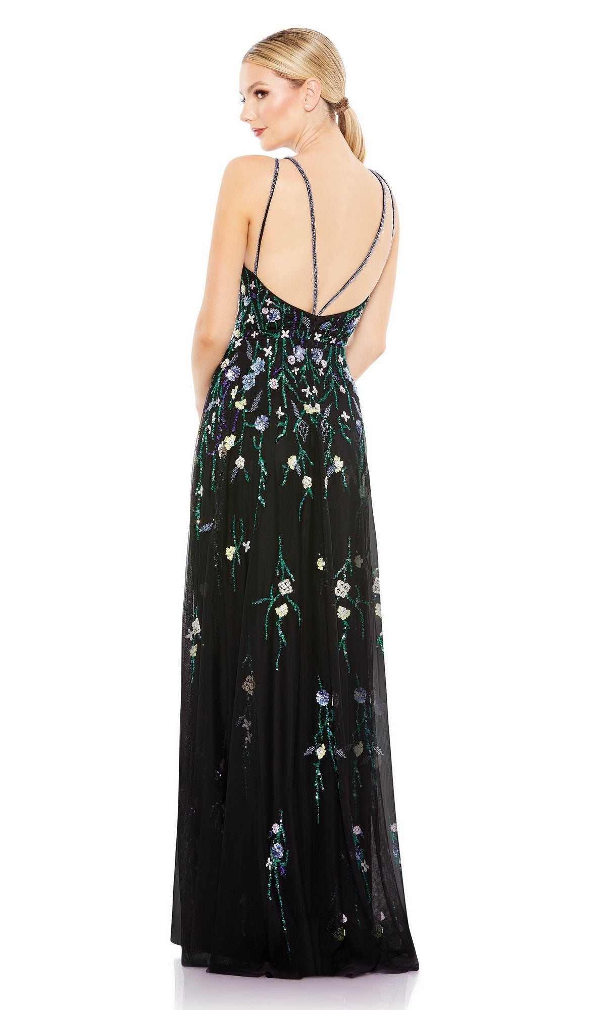 A woman with blond hair in a ponytail is seen elegantly from the back wearing the Floral-Sequin Long Black Formal Dress 9172 by Mac Duggal, featuring thin straps and sequin floral details.