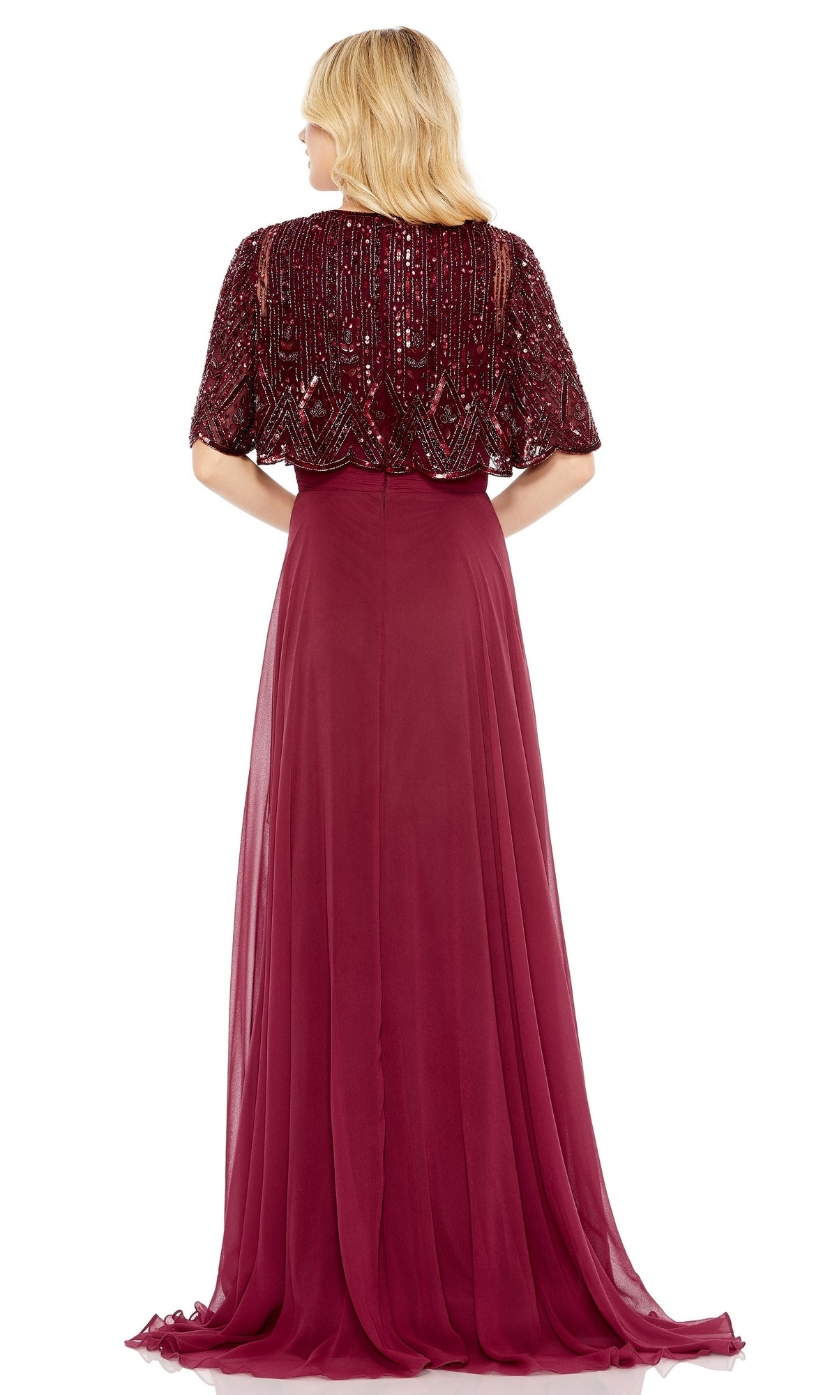 A woman faces away, wearing the Mac Duggal 9181 Cape Sleeve Long Formal Dress—a floor-length burgundy gown featuring a beaded capelet top and flowing chiffon skirt.