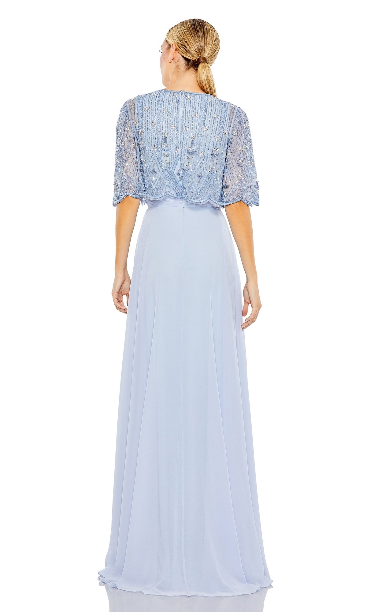 Woman in a light blue Mac Duggal 9181 cape sleeve long formal dress, with beaded short-sleeve overlay, standing with her back to the camera.