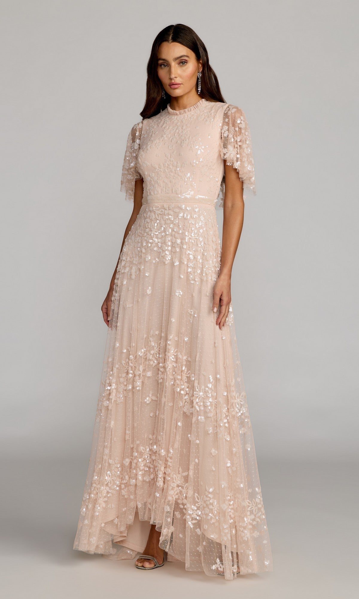 Woman wearing a floor-length, short-sleeve blue formal dress (Mac Duggal 9192) with elegant detailing, standing against a plain background.